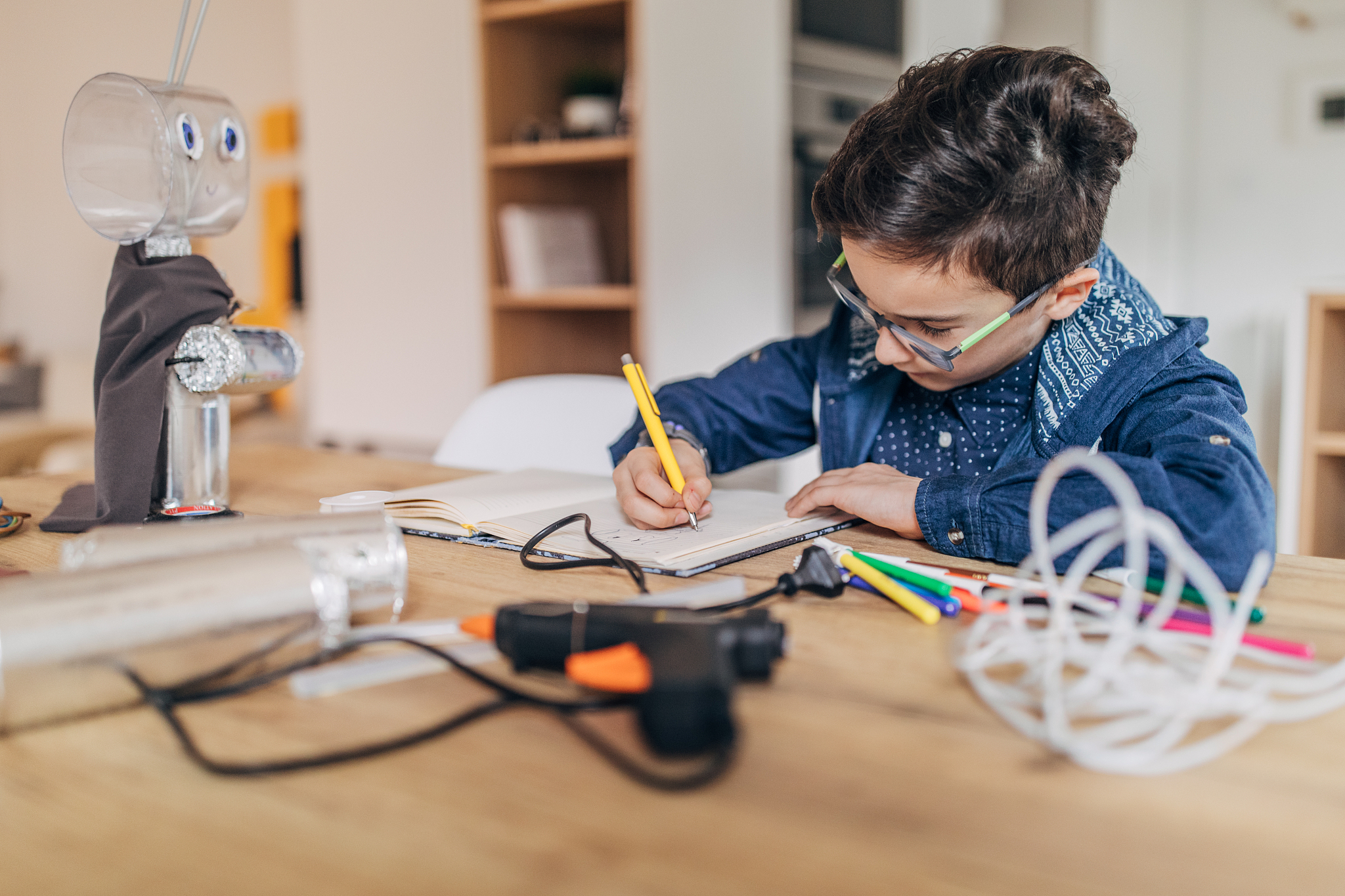 boy constructing a robot at home
