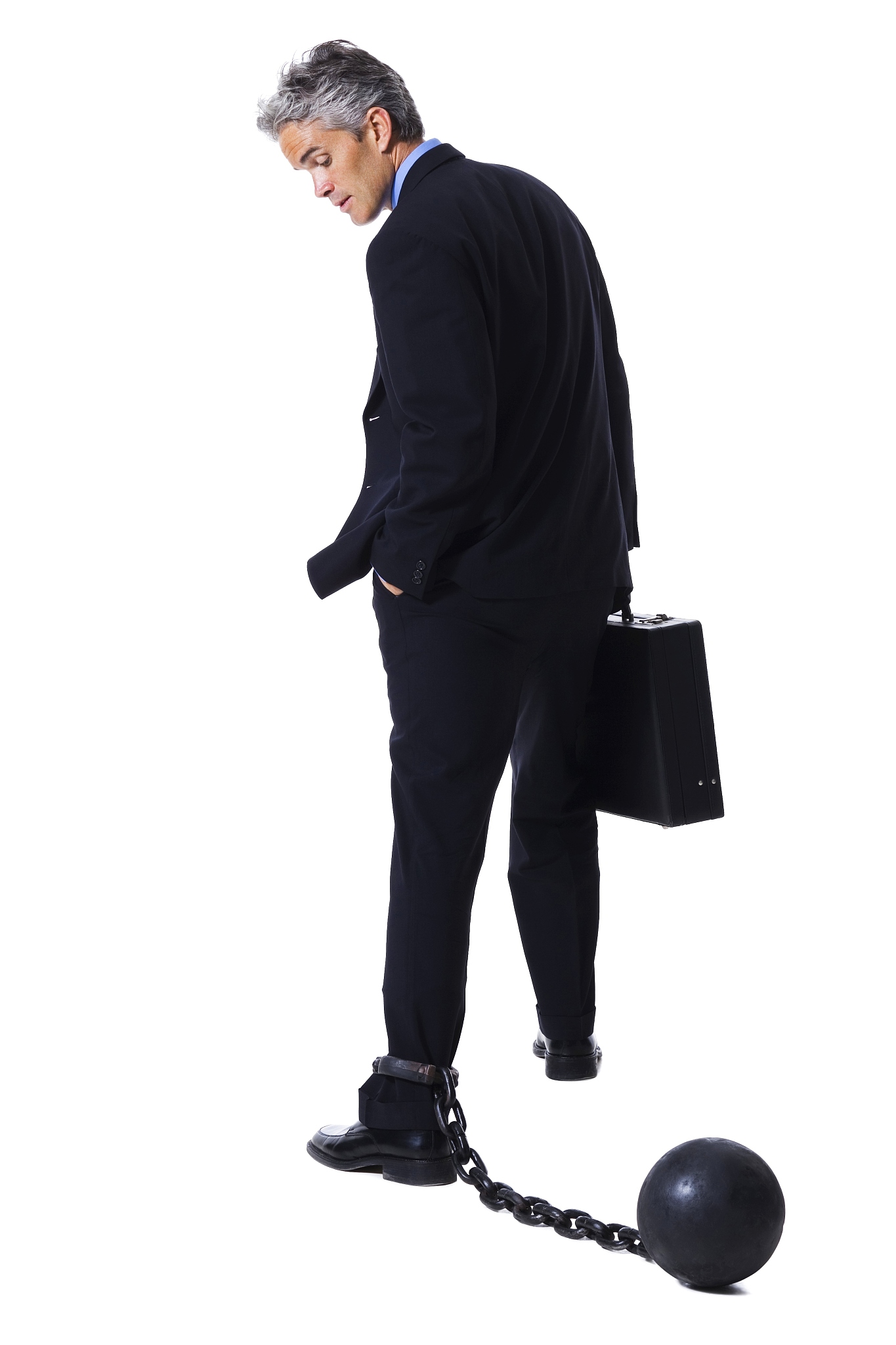 businessman shackled to ball and chain