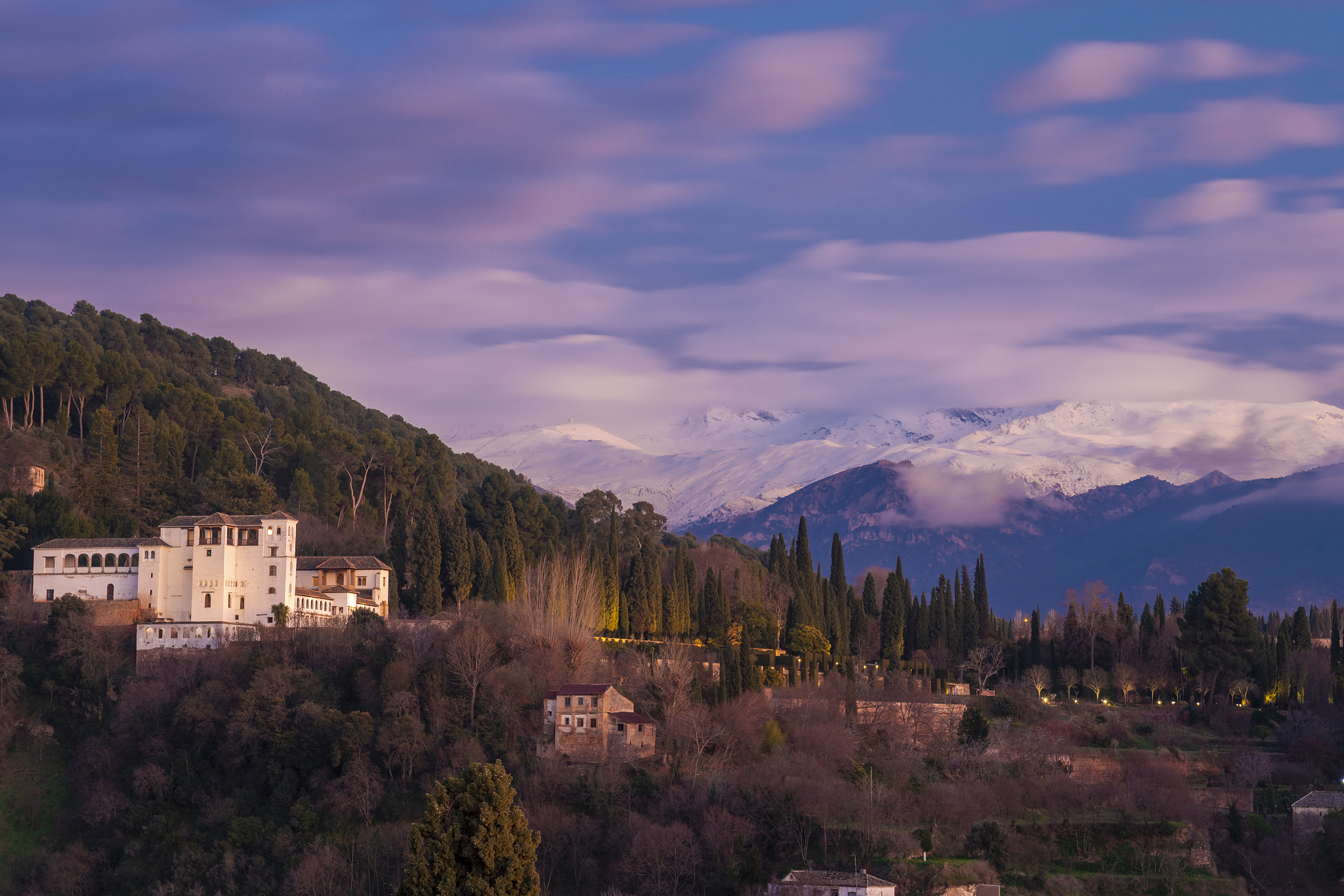 view of alhambra with sierra nevada in the background at sunset,