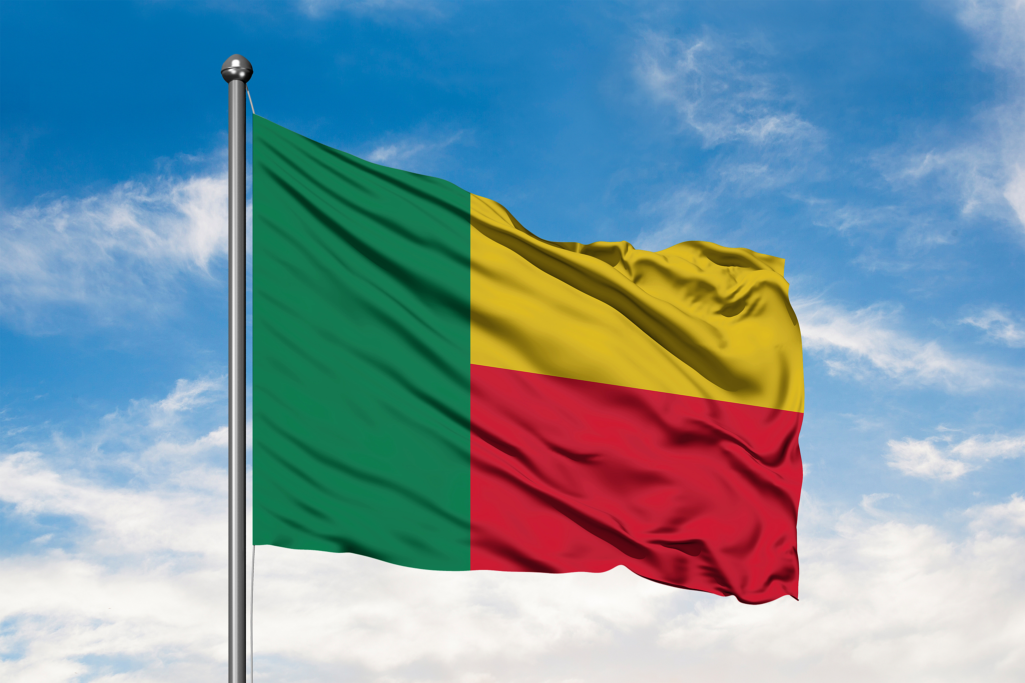 flag of benin waving in the wind against white cloudy blue sky. 