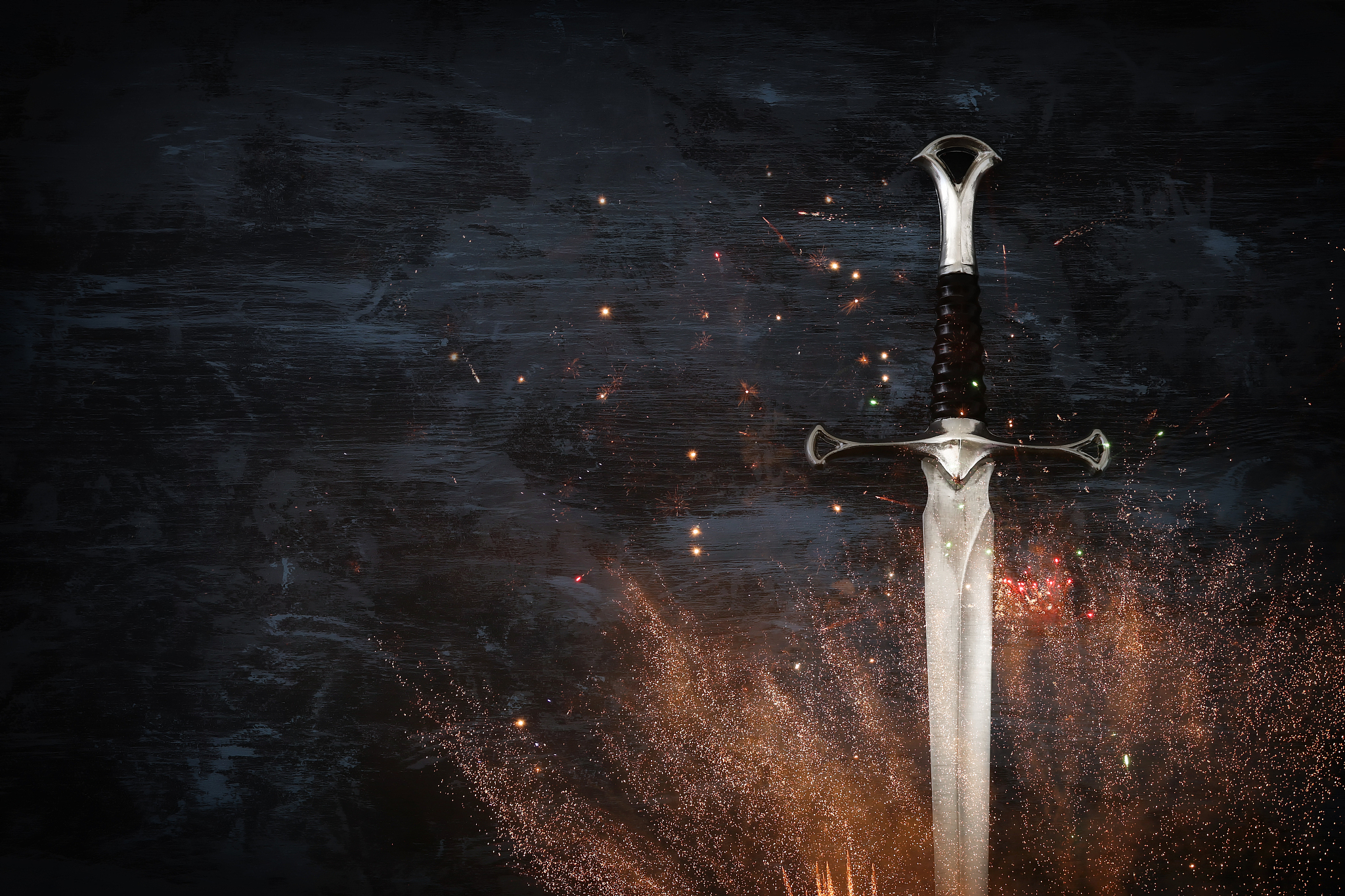 low key image of silver sword with fire sparks. fantasy medieval