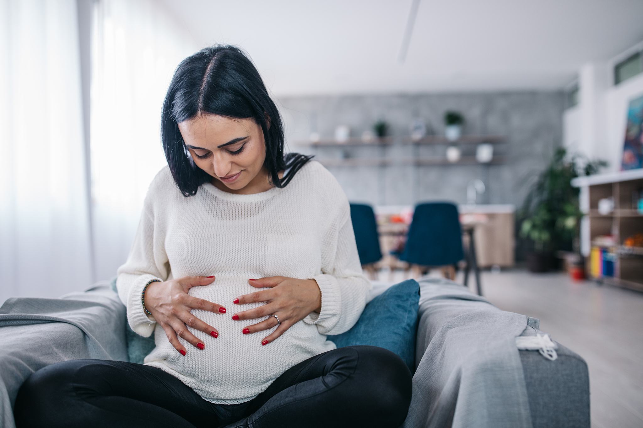 pregnant woman holding her belly