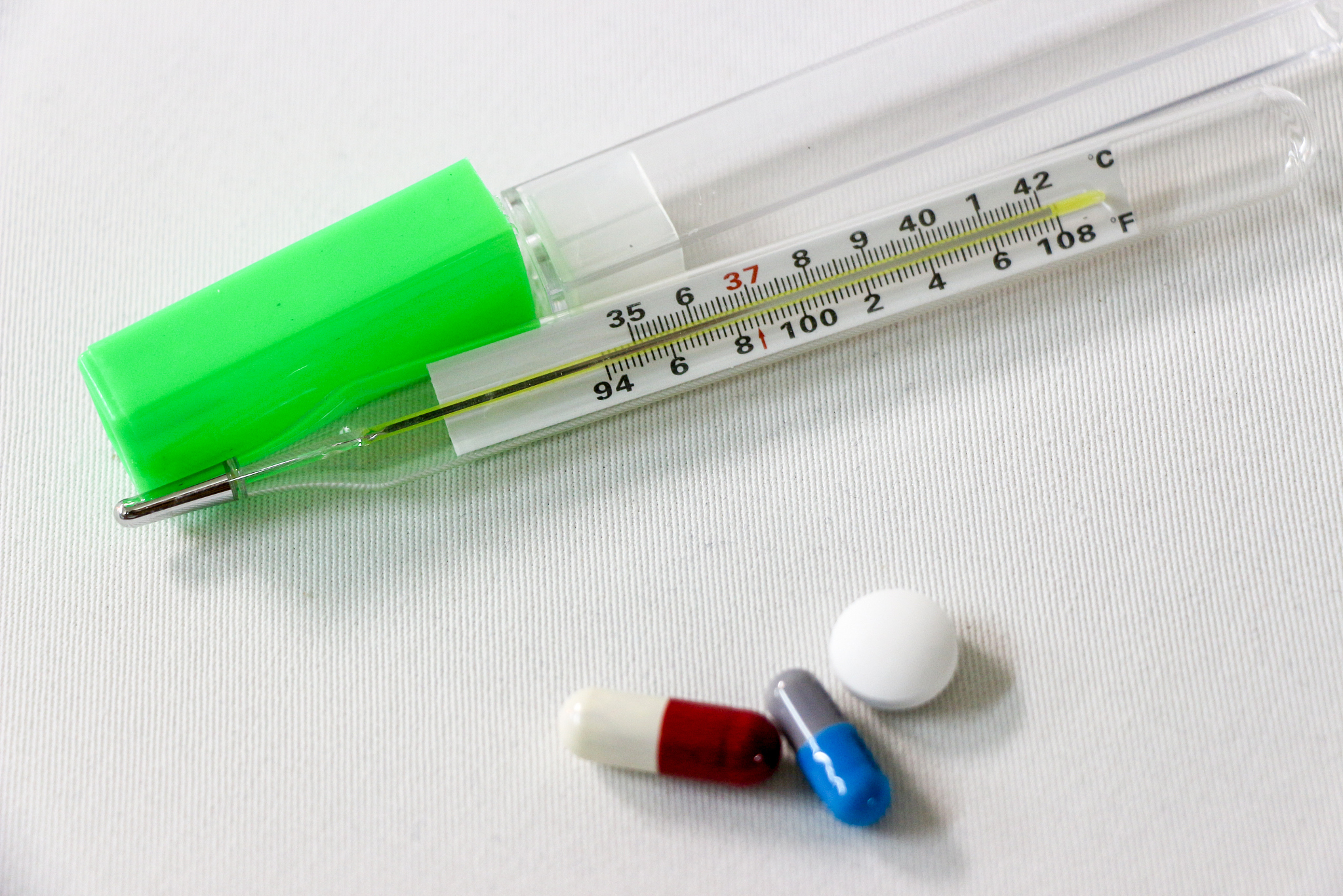 close-up various pills and thermometer