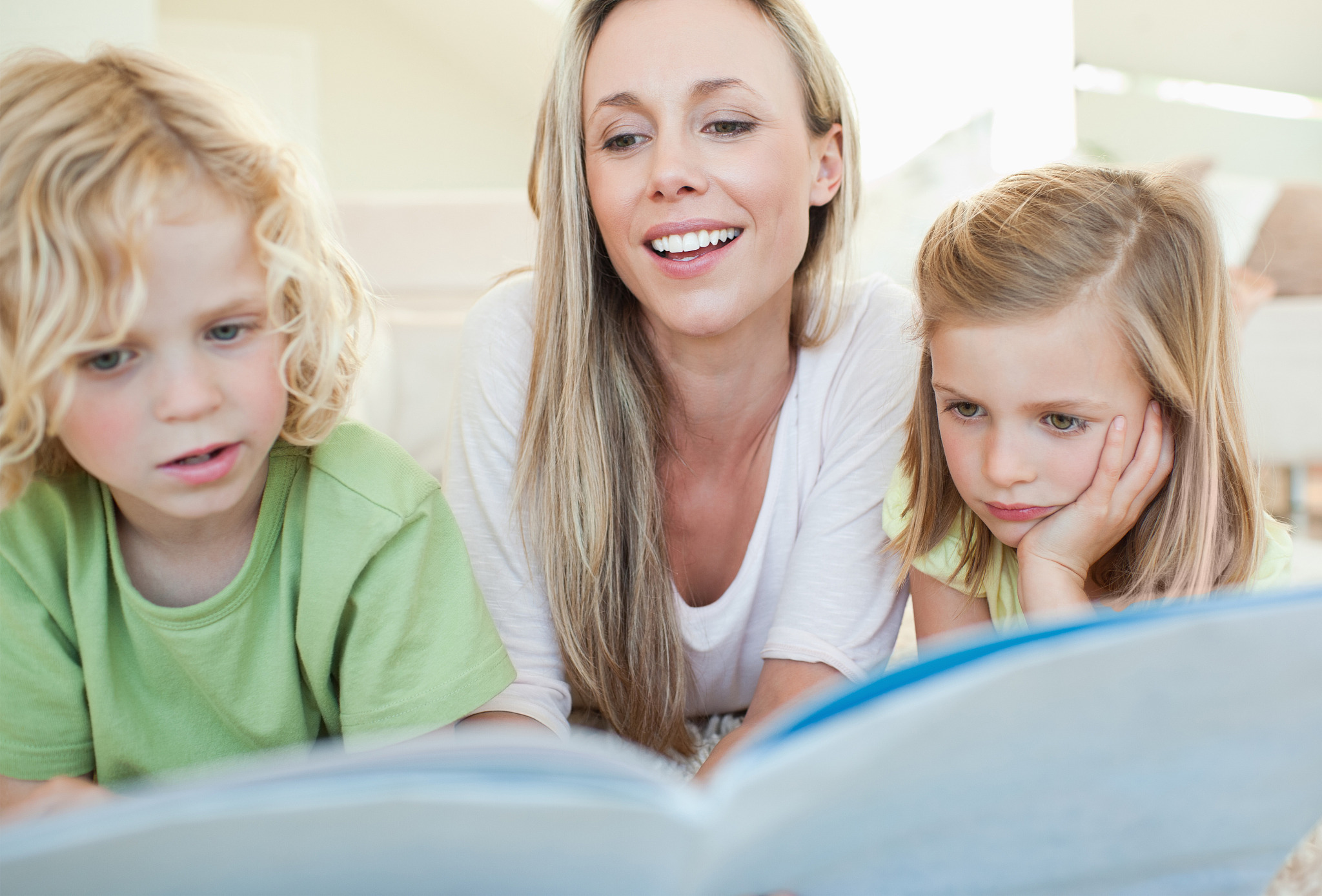 mother reading magazine together with her children