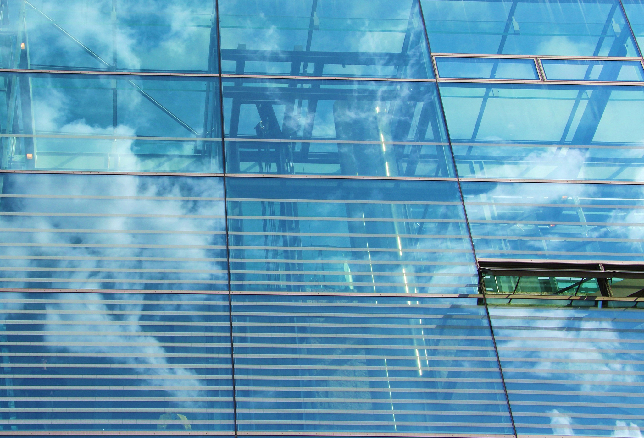 glass facade with clouds reflection