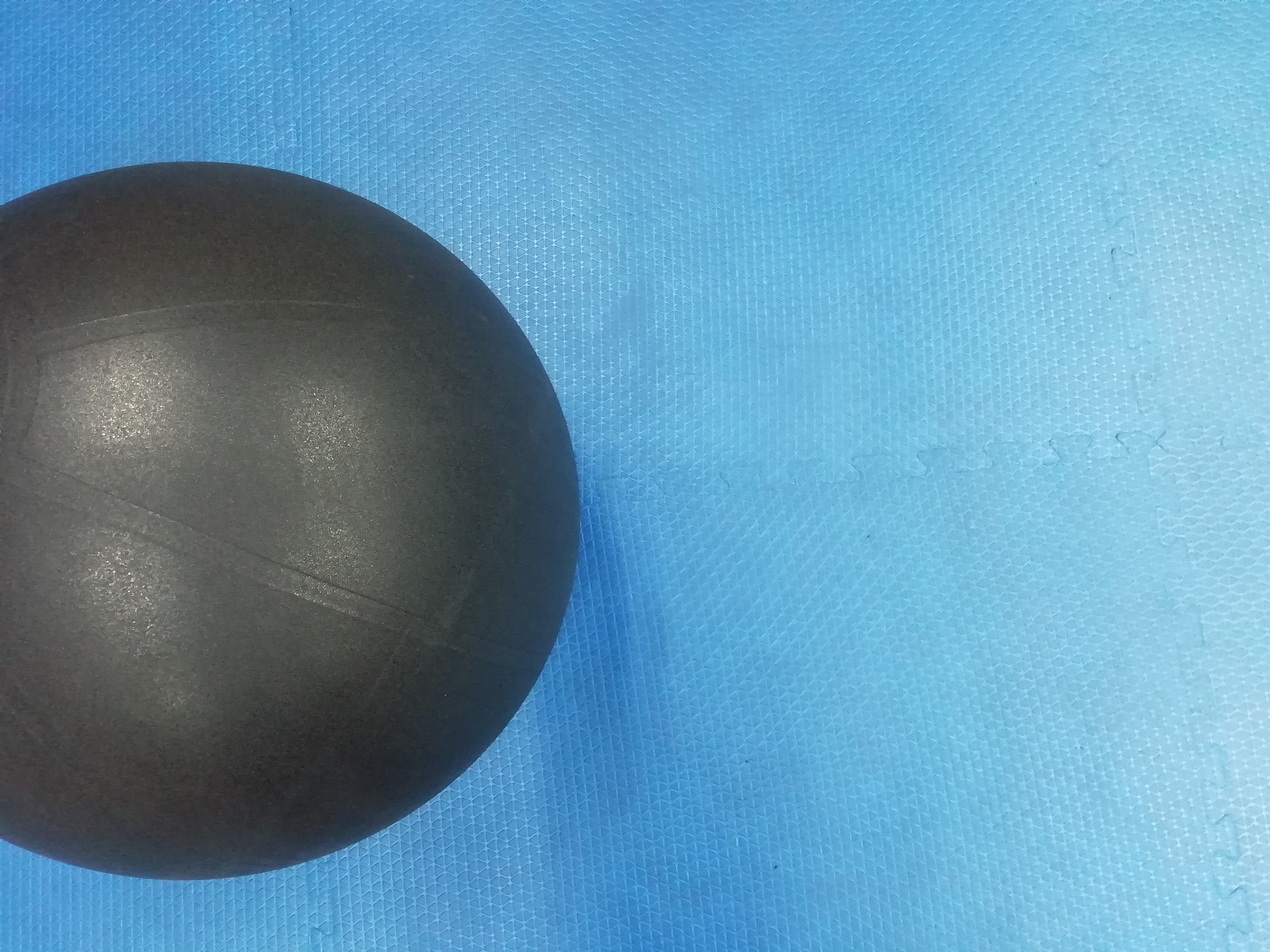 big round black ball on a blue background