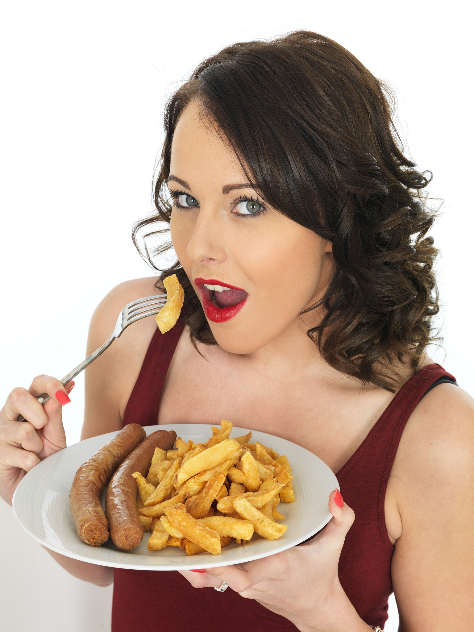 young woman eating high calorie jumbo sausage and chips meal