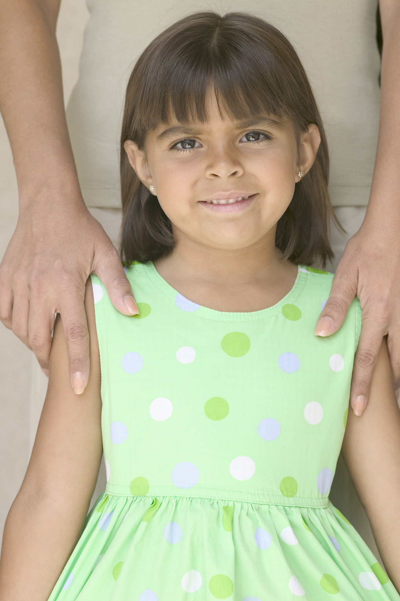 portrait of a young girl standing in front of a young woman