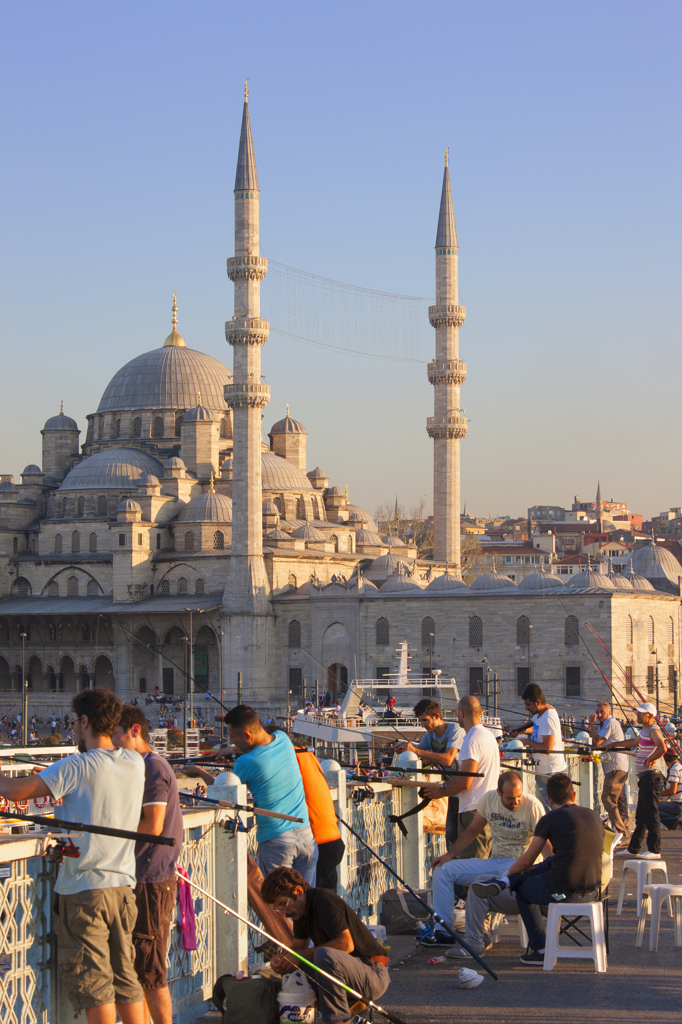 fisherman on galata bridge in front of new mosque