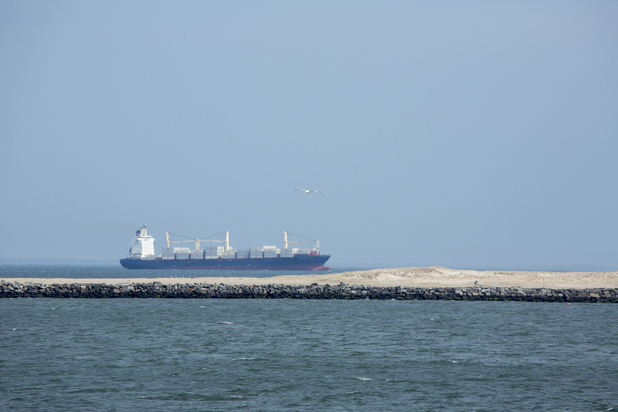 container ship passes the breakwater at lewes, delaware.