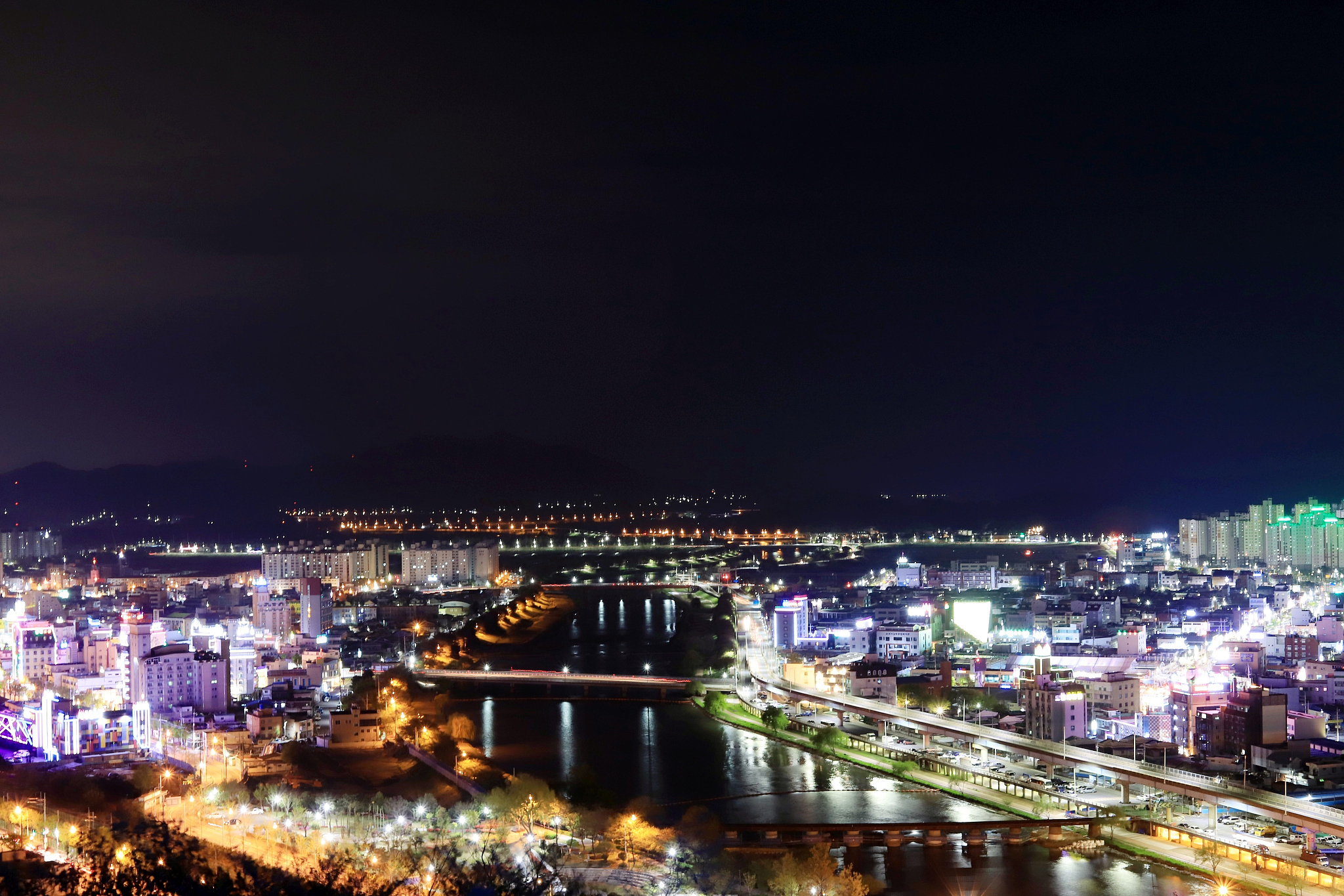 high angle view of illuminated buildings against sky at night