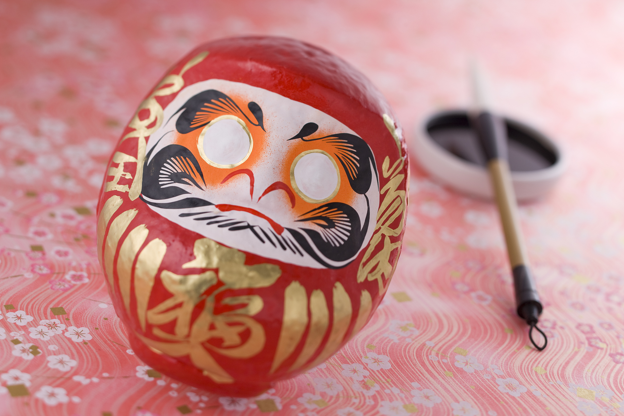 daruma doll and calligraphy brush