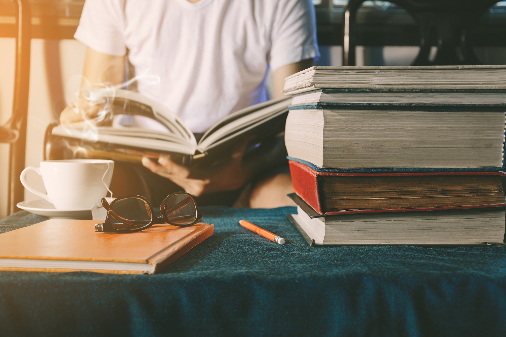 men read book on table in the house