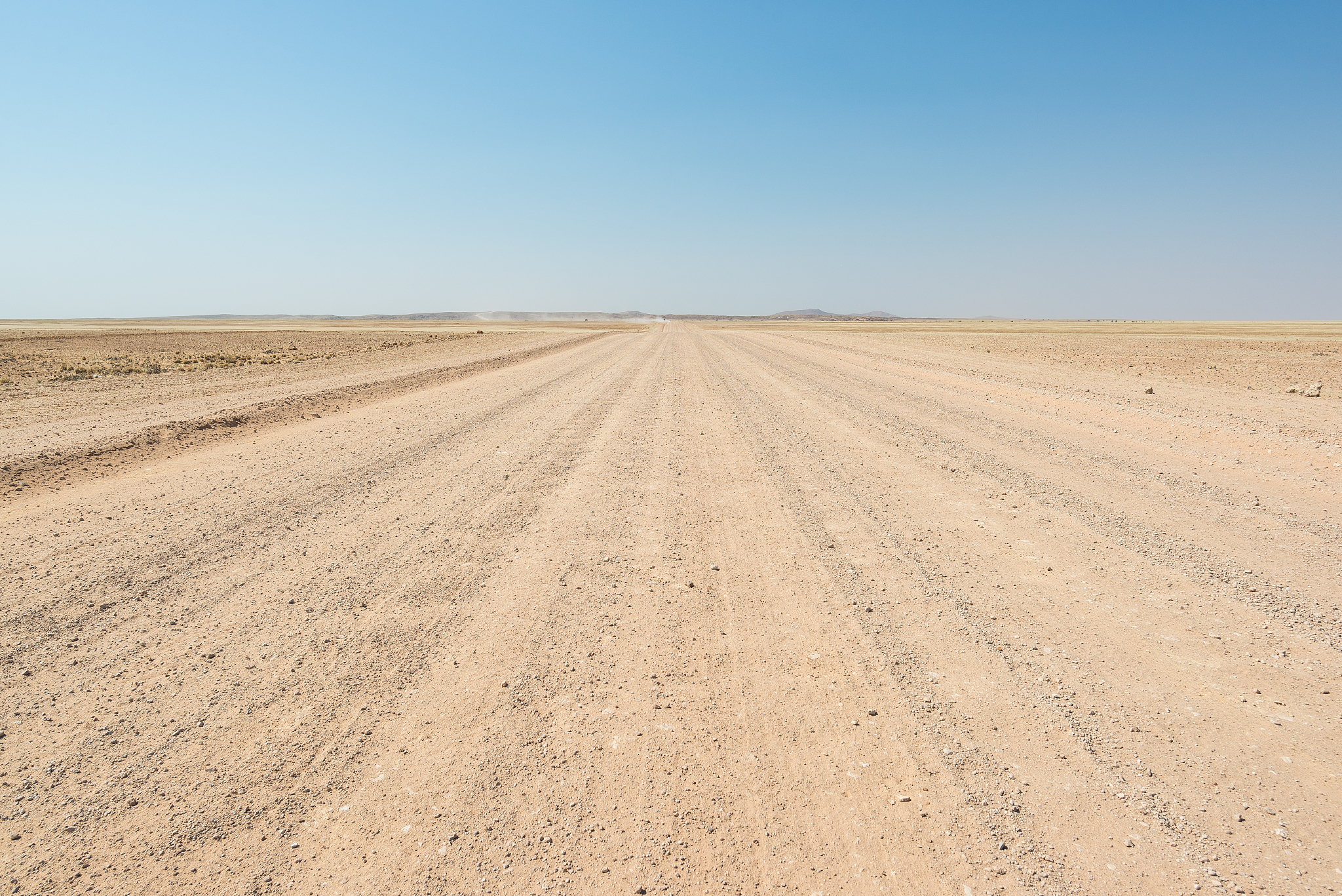 gravel road crossing the namib desert, namibia, africa