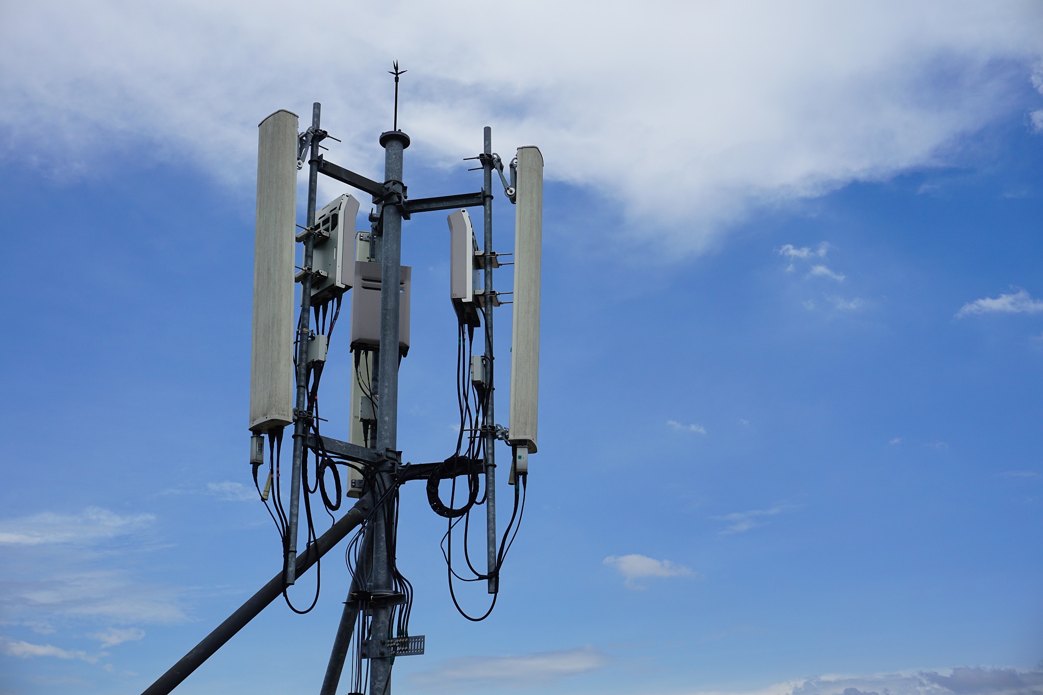 cell phone telecommunication tower with clouds,blue sky