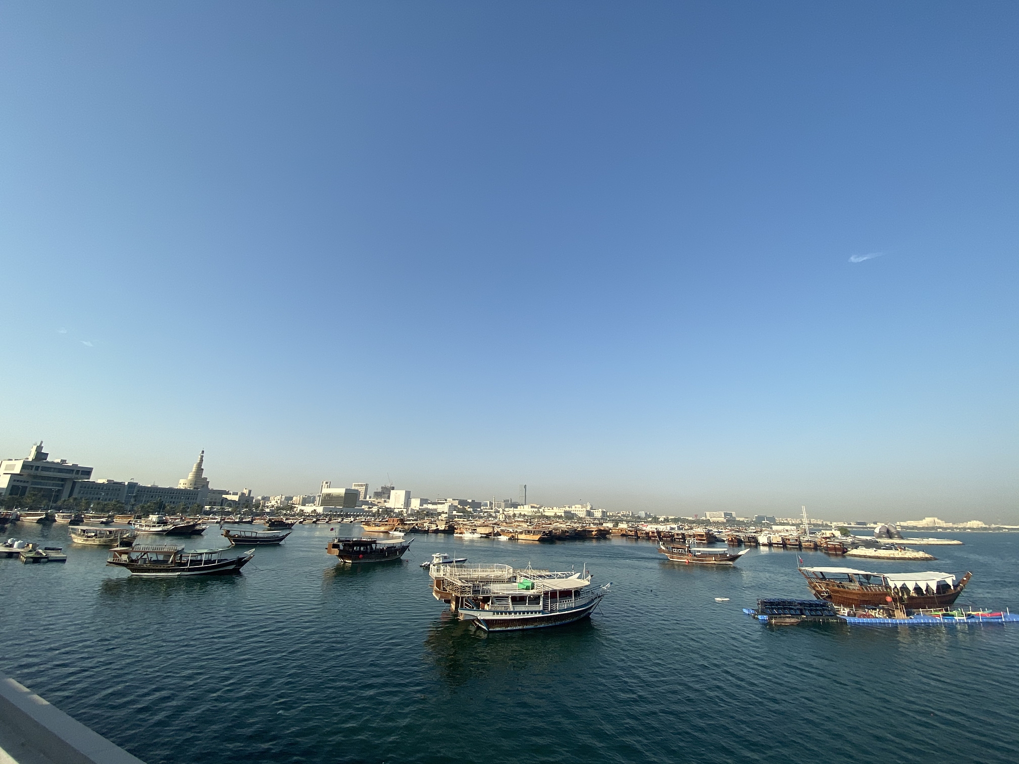 sailboats moored in harbor against clear blue sky