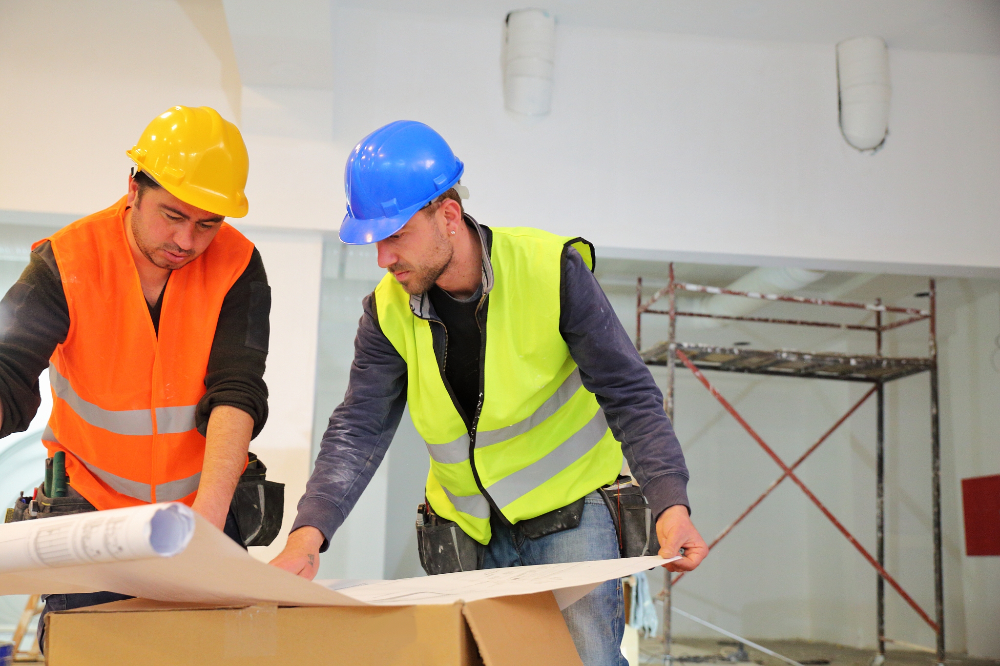 construction workers reading blueprints