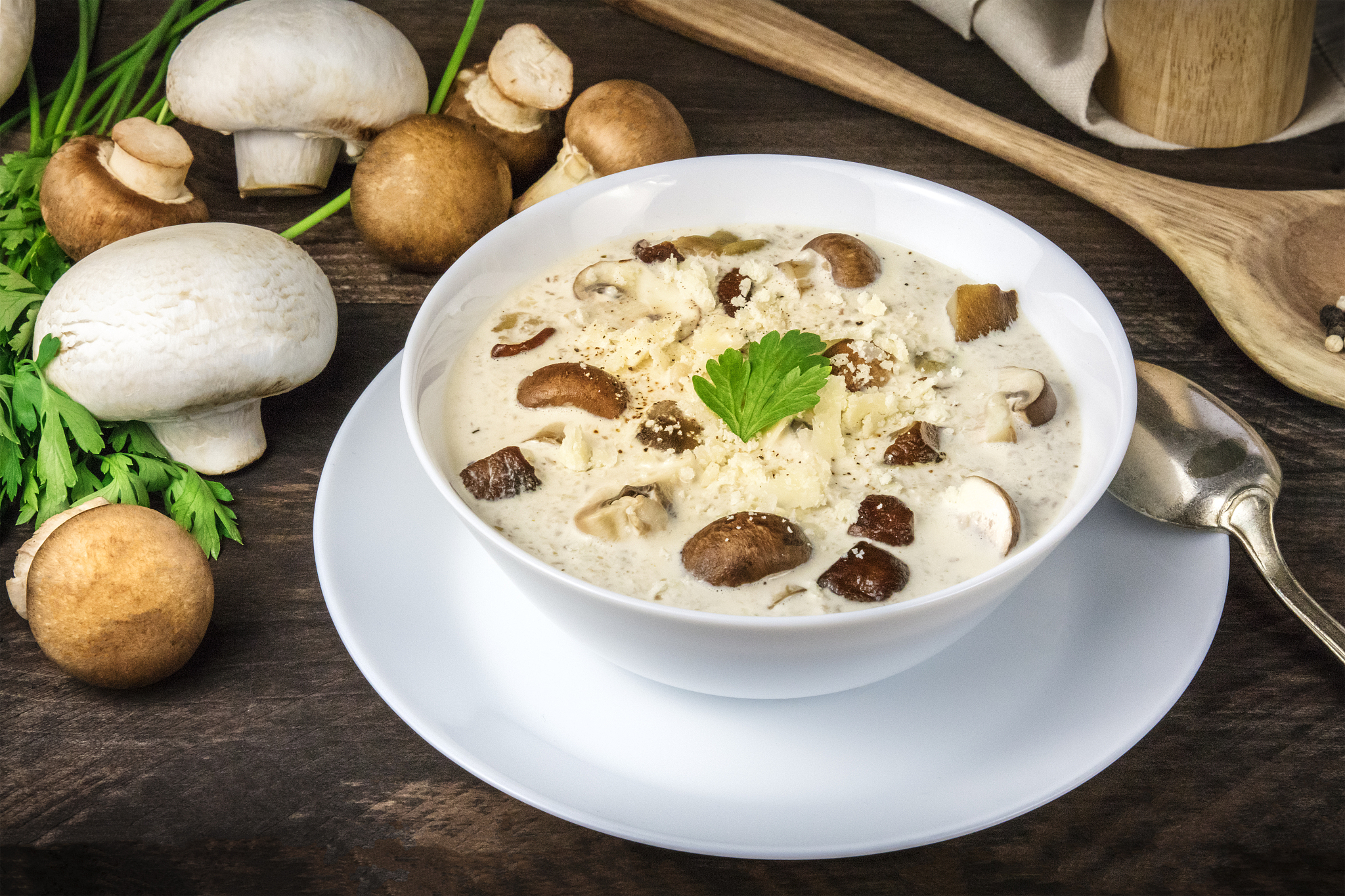 mushroom soup with ingredients on a dark rustic wooden backgroun