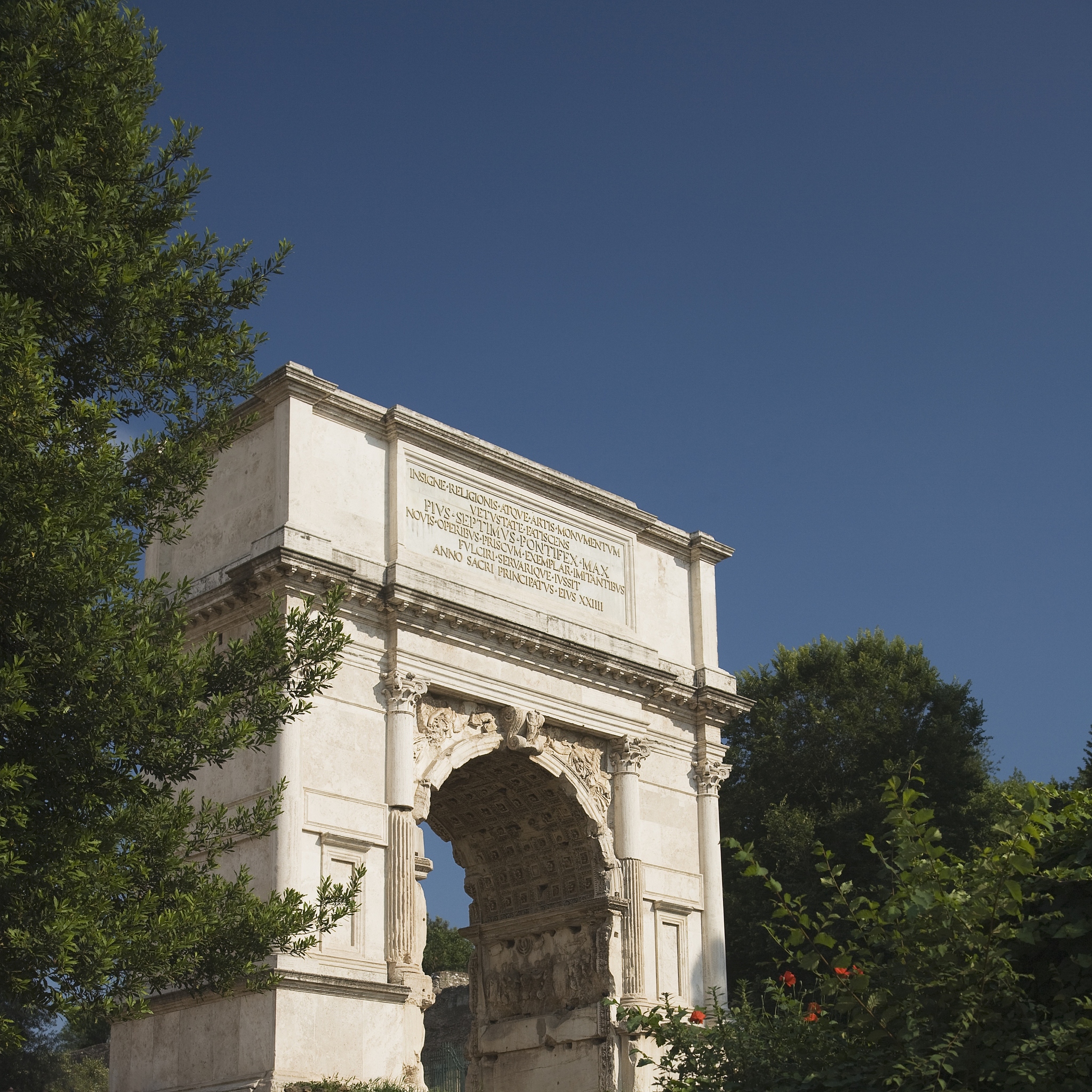 the arch of titus under blue sky, roman forum, italy