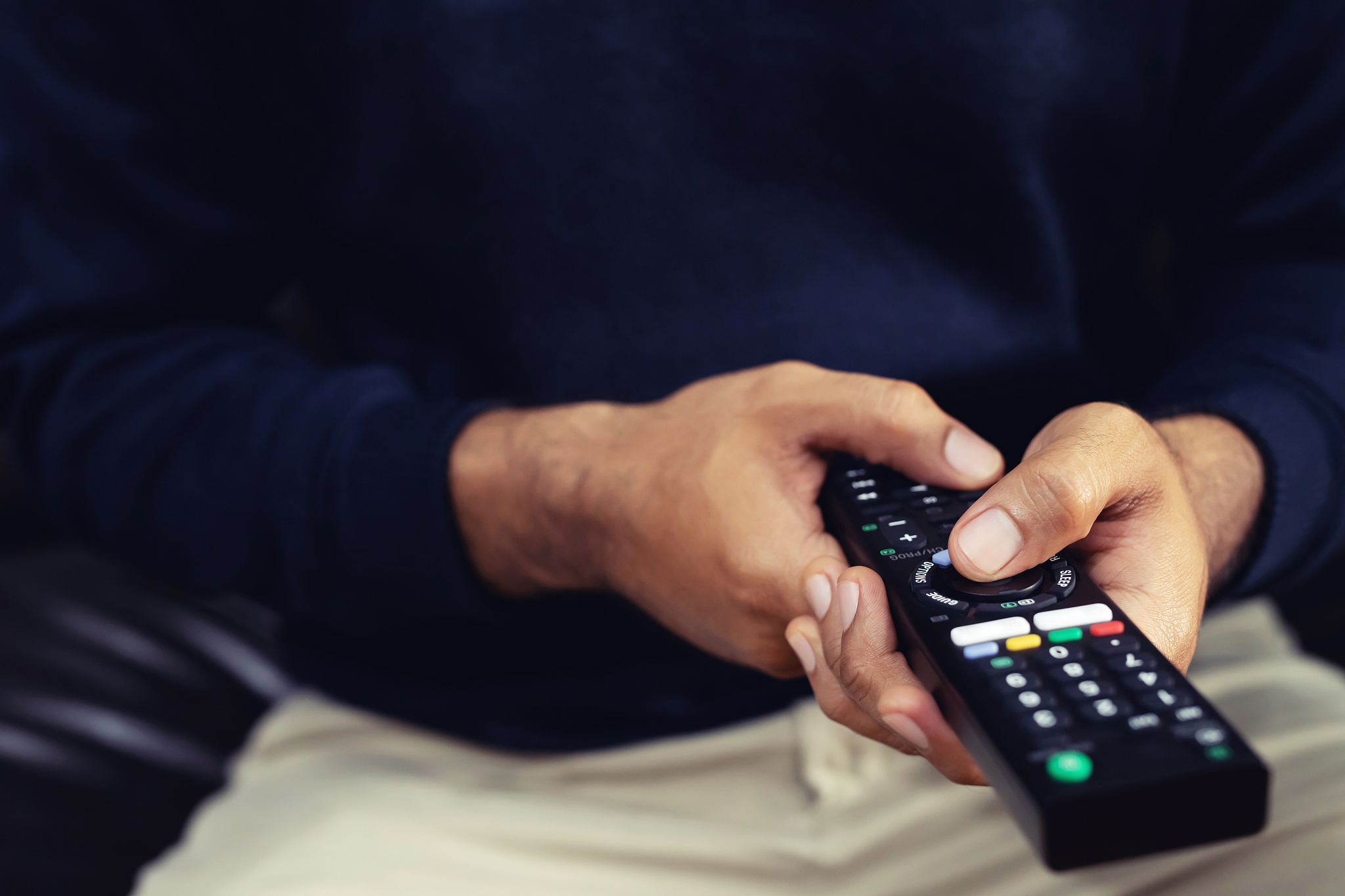 a man is watching a live broadcast of the world cup on tv at hom