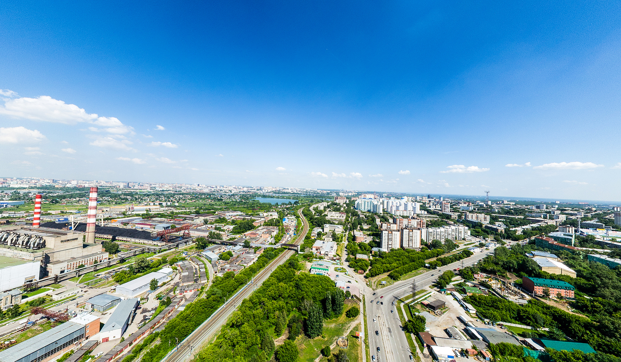 aerial city view with roads, houses and buildings