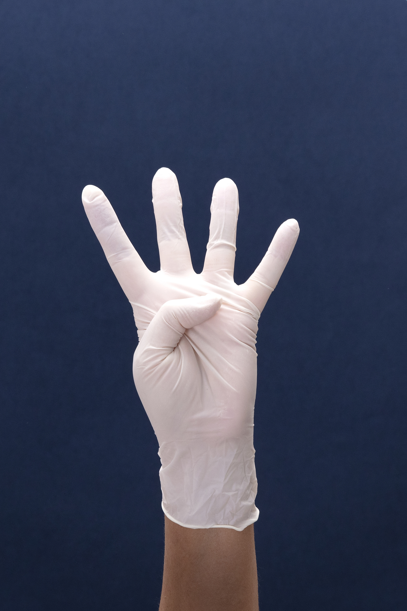 doctor hand with white medical glove showing number four with fi