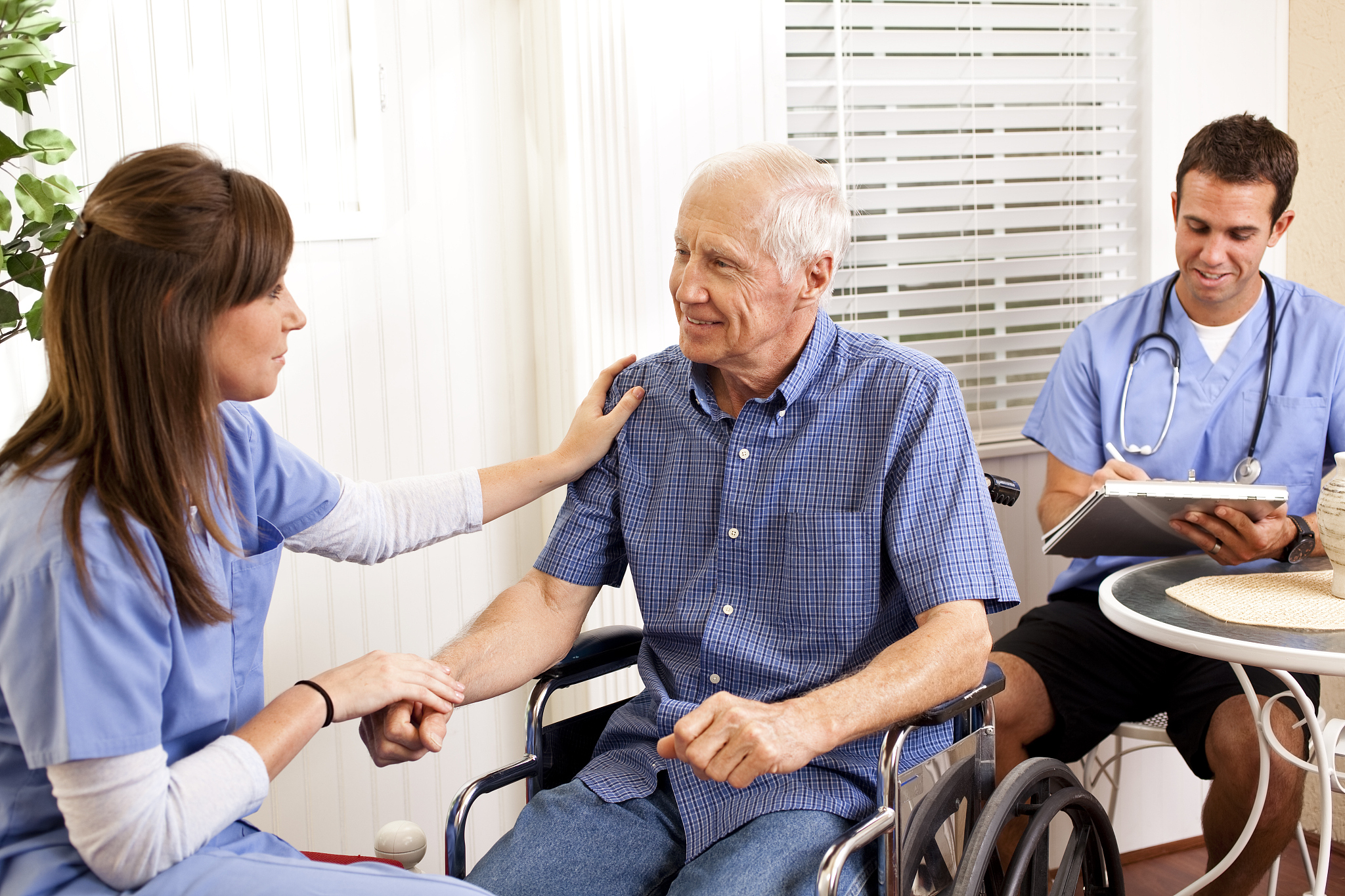 physical therapist or nurse consoling patient