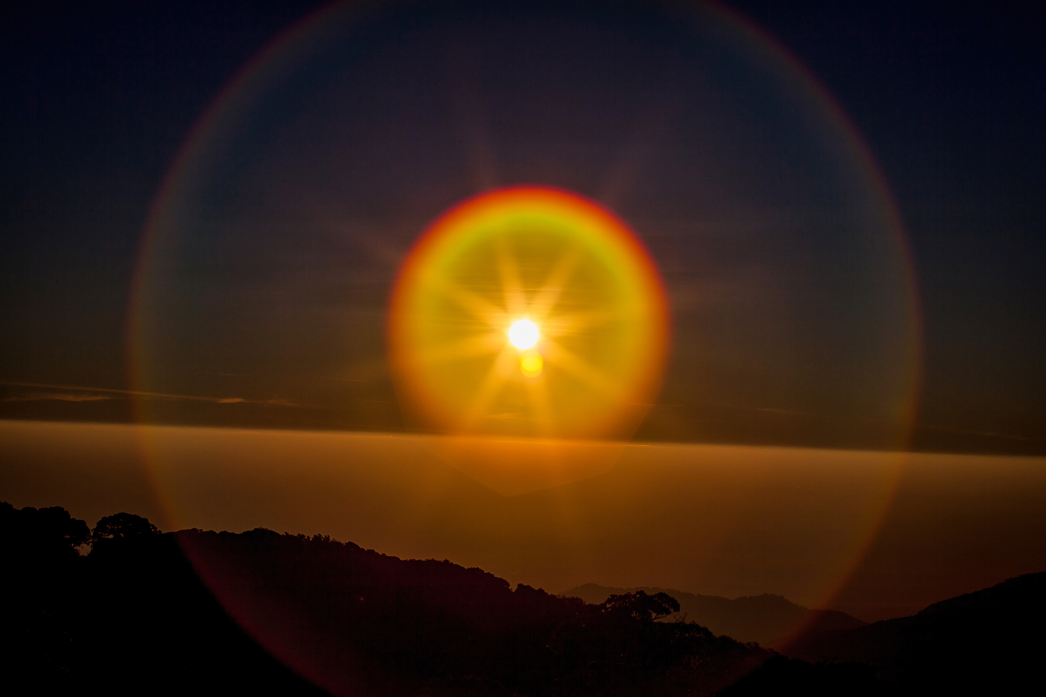 sun flare  with golden sunrise or sunset sky on the mountains.