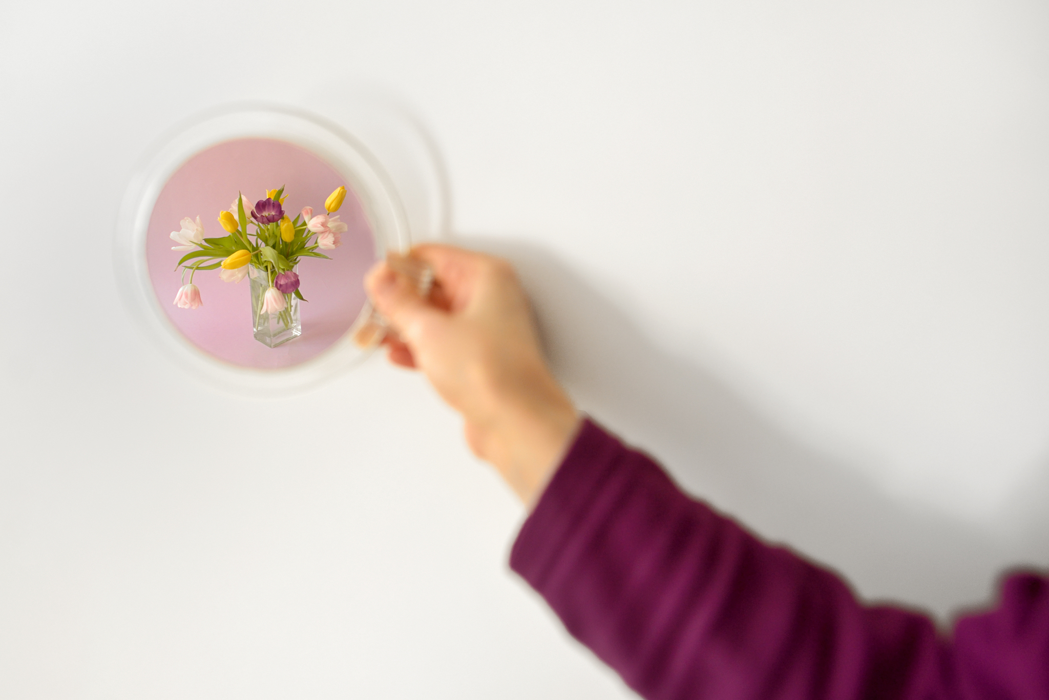 looking into mirror and seeing floral arrangement