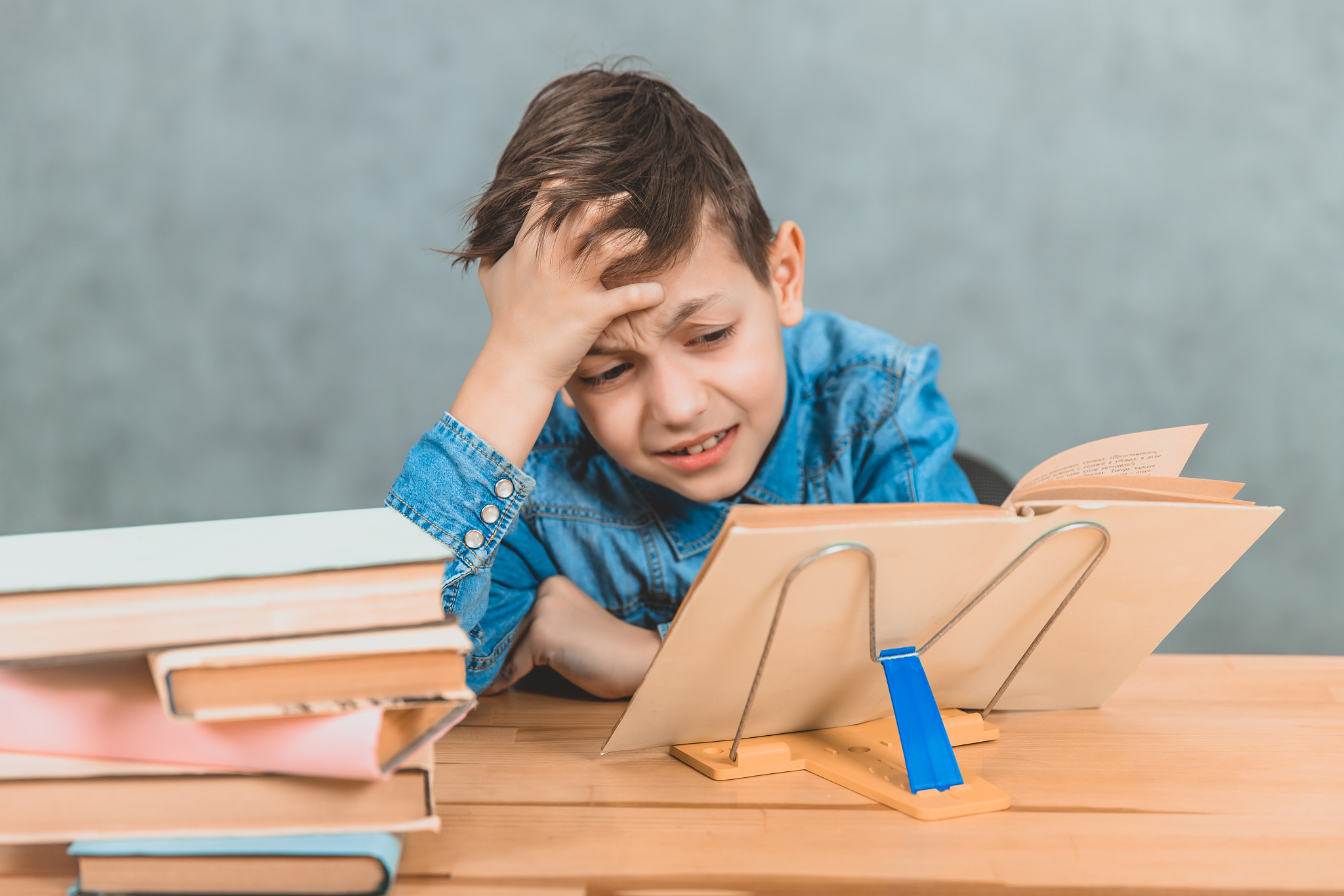 cute little pupil cannot solve the task, so he leaned head on th