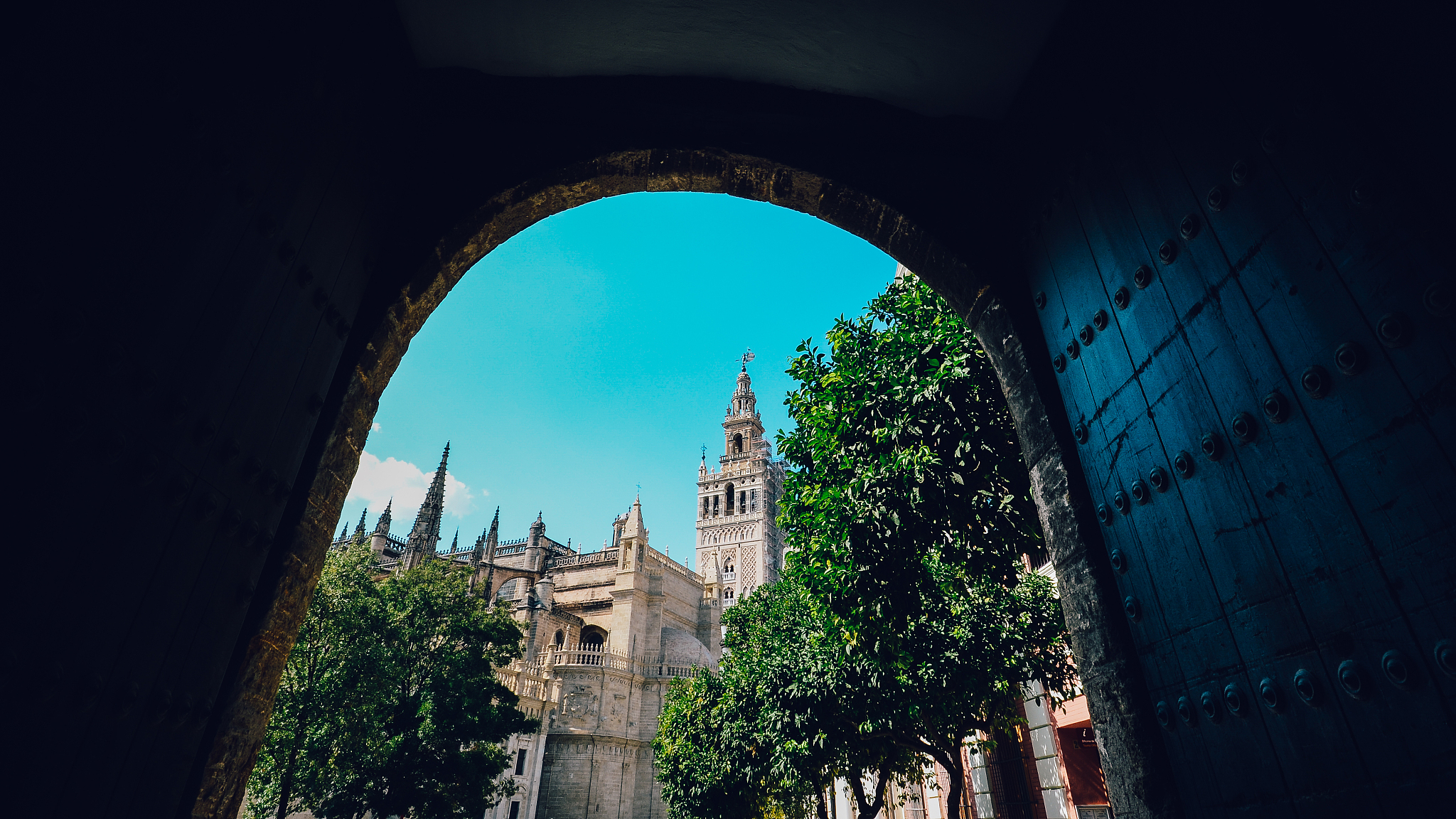seville cathedral giralda tower from alcazar arch door of sevill