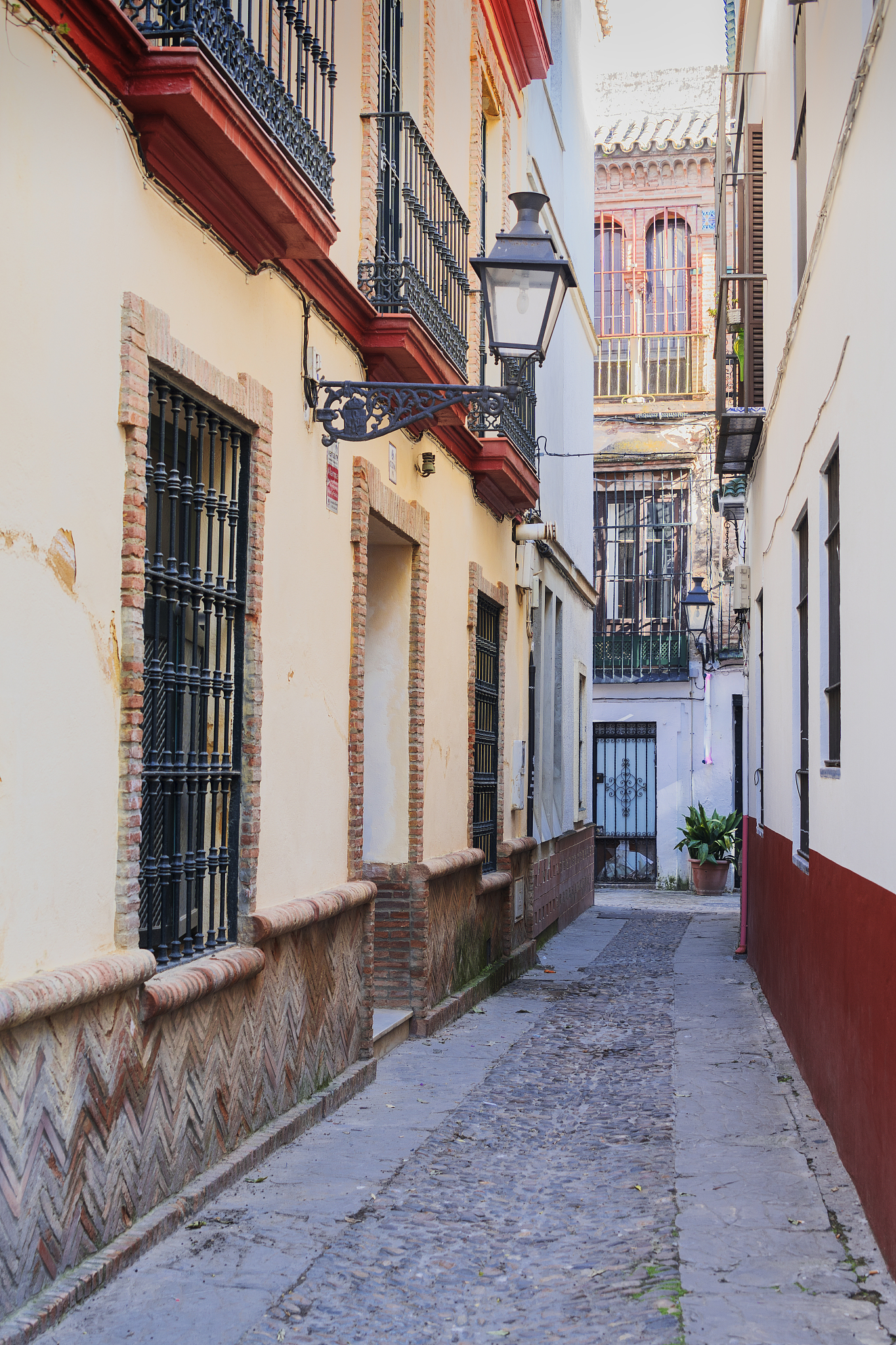 narrow alley amidst buildings in seville, andalusia, spain
