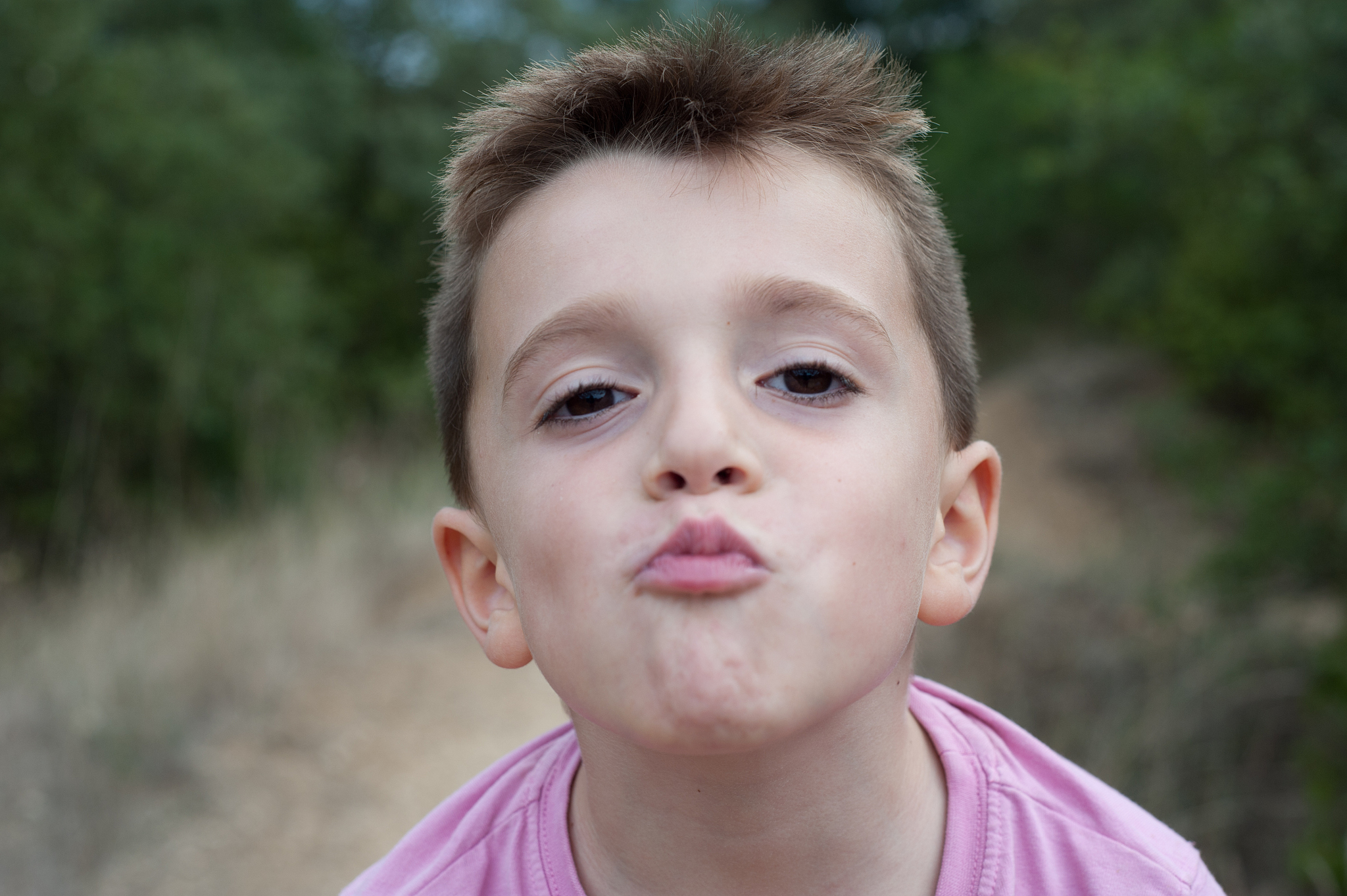 portrait of a boy making a kiss