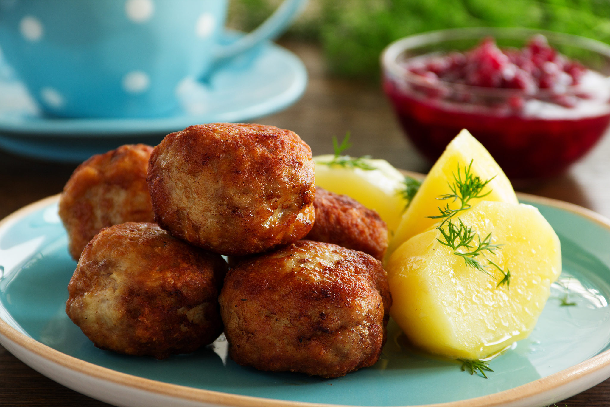 hot meatballs with boiled potatoes and cranberry sauce ..