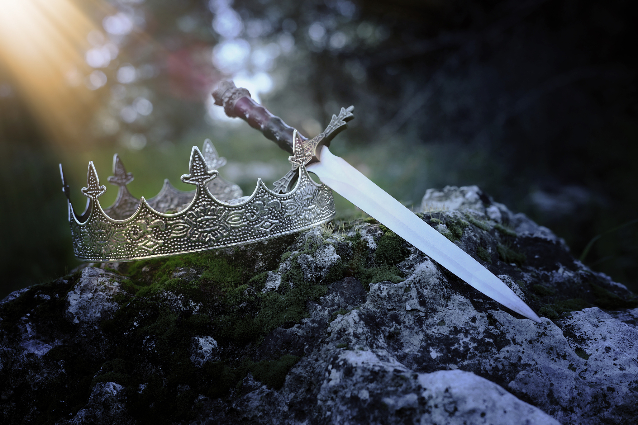mysterious and magical photo of silver king crown and sword over