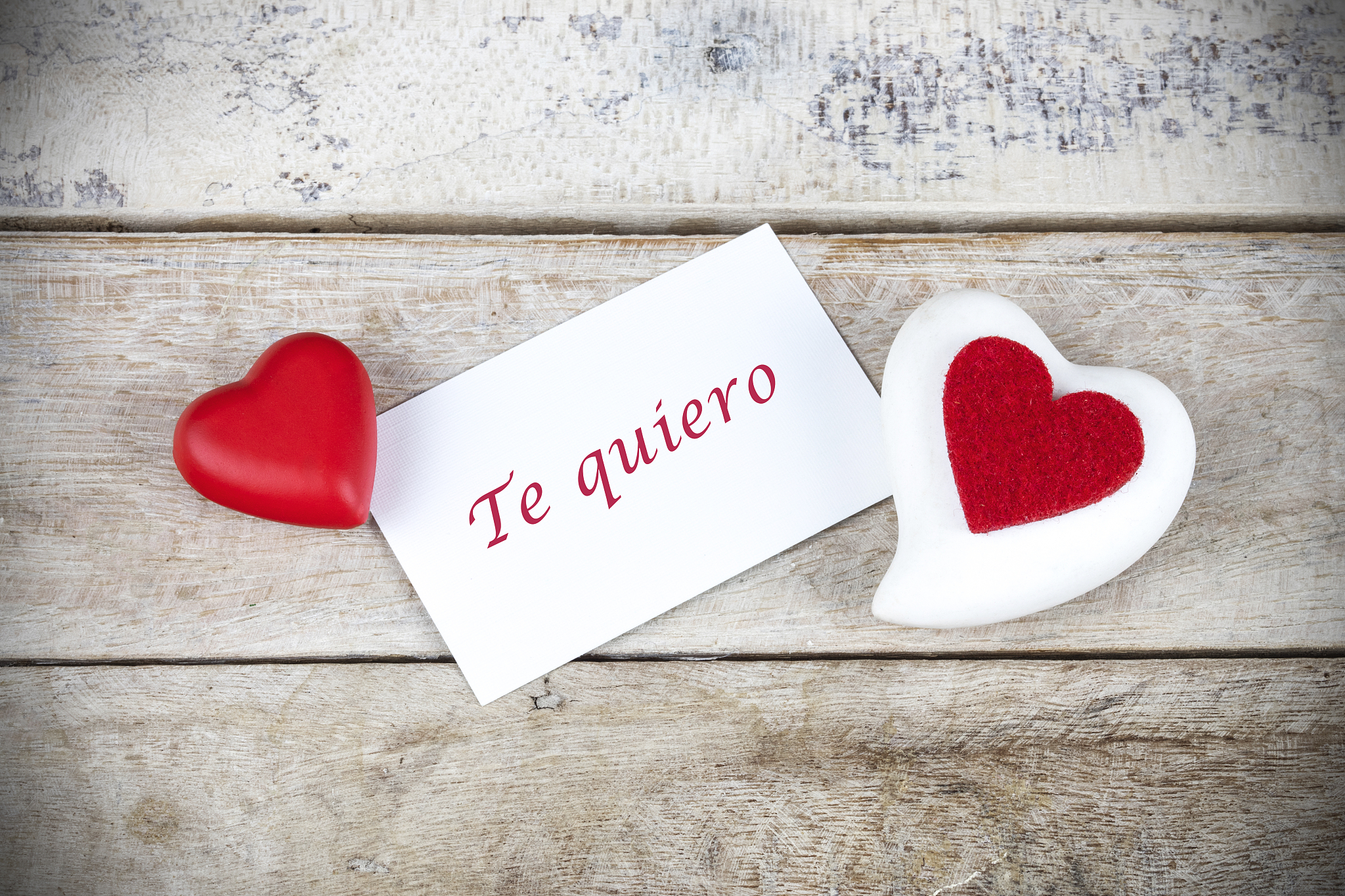 valentine greeting card on wooden table with text written in spa