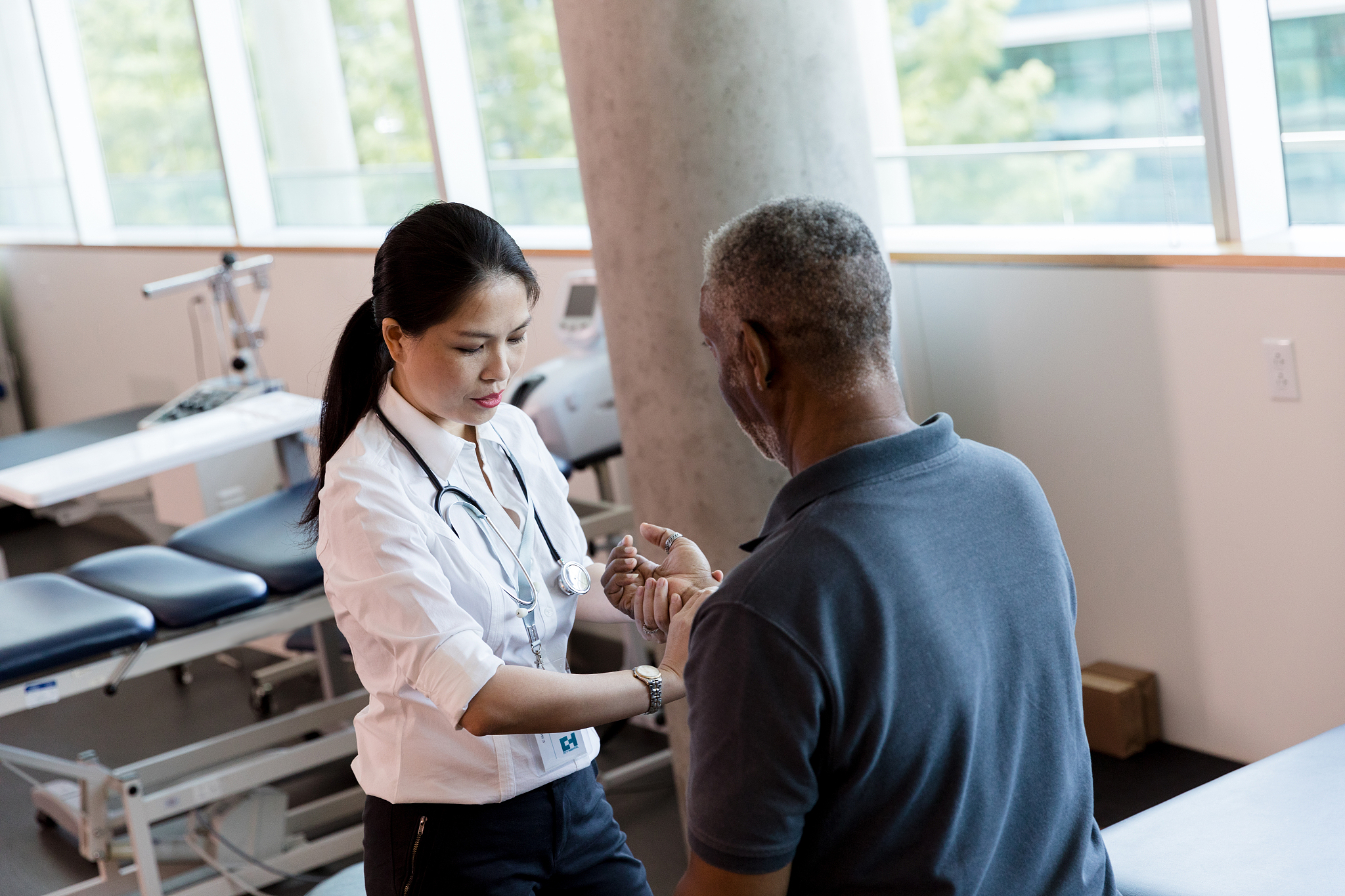female physical therapist checks unrecognizable mature patient