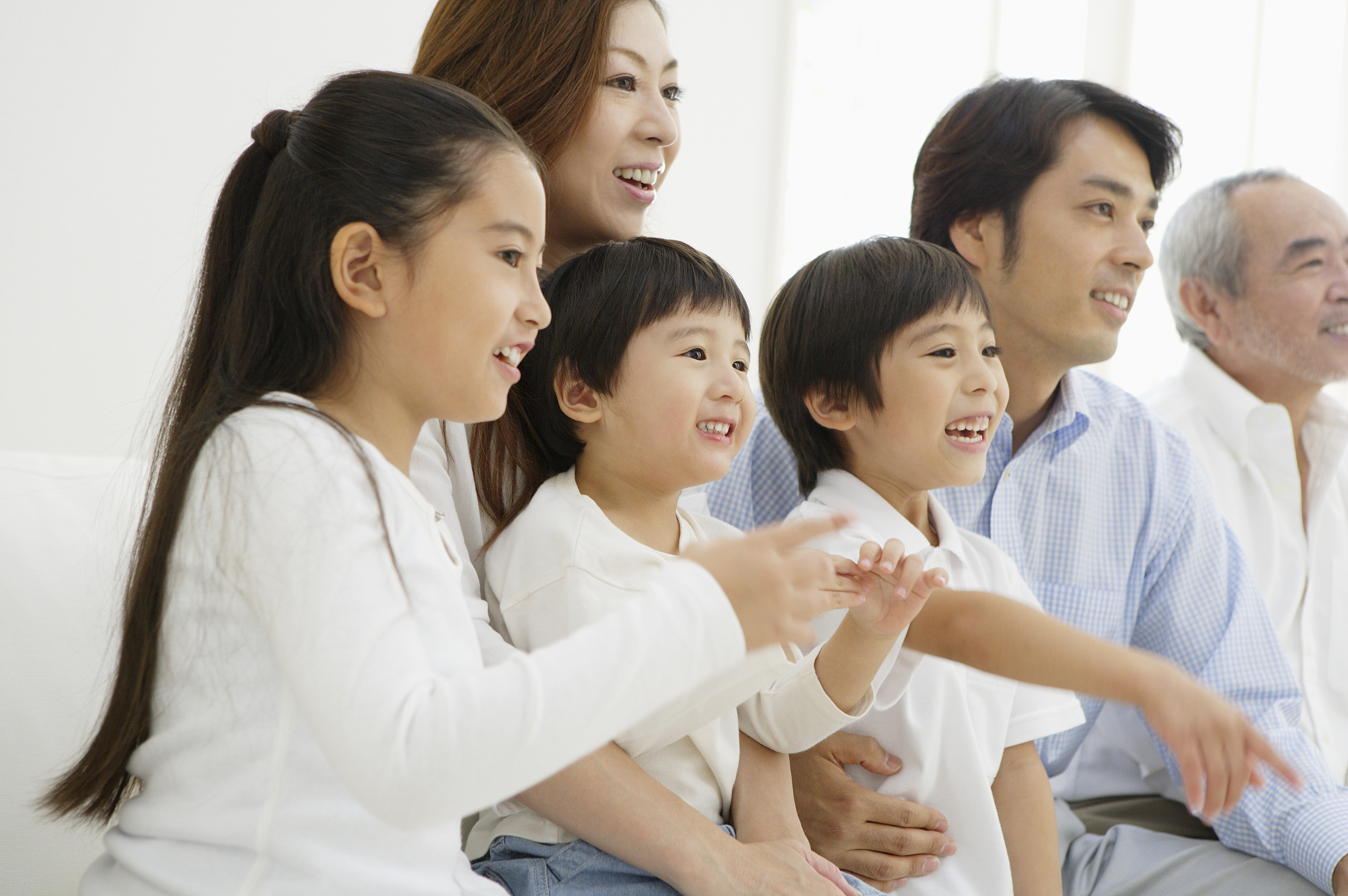 multi-generation family watching tv