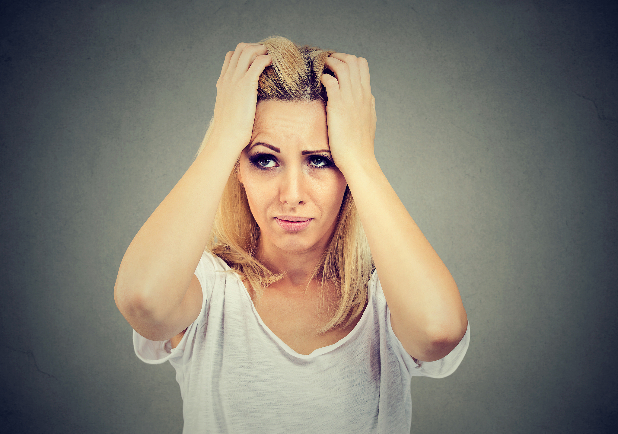desperate woman holding hand on head