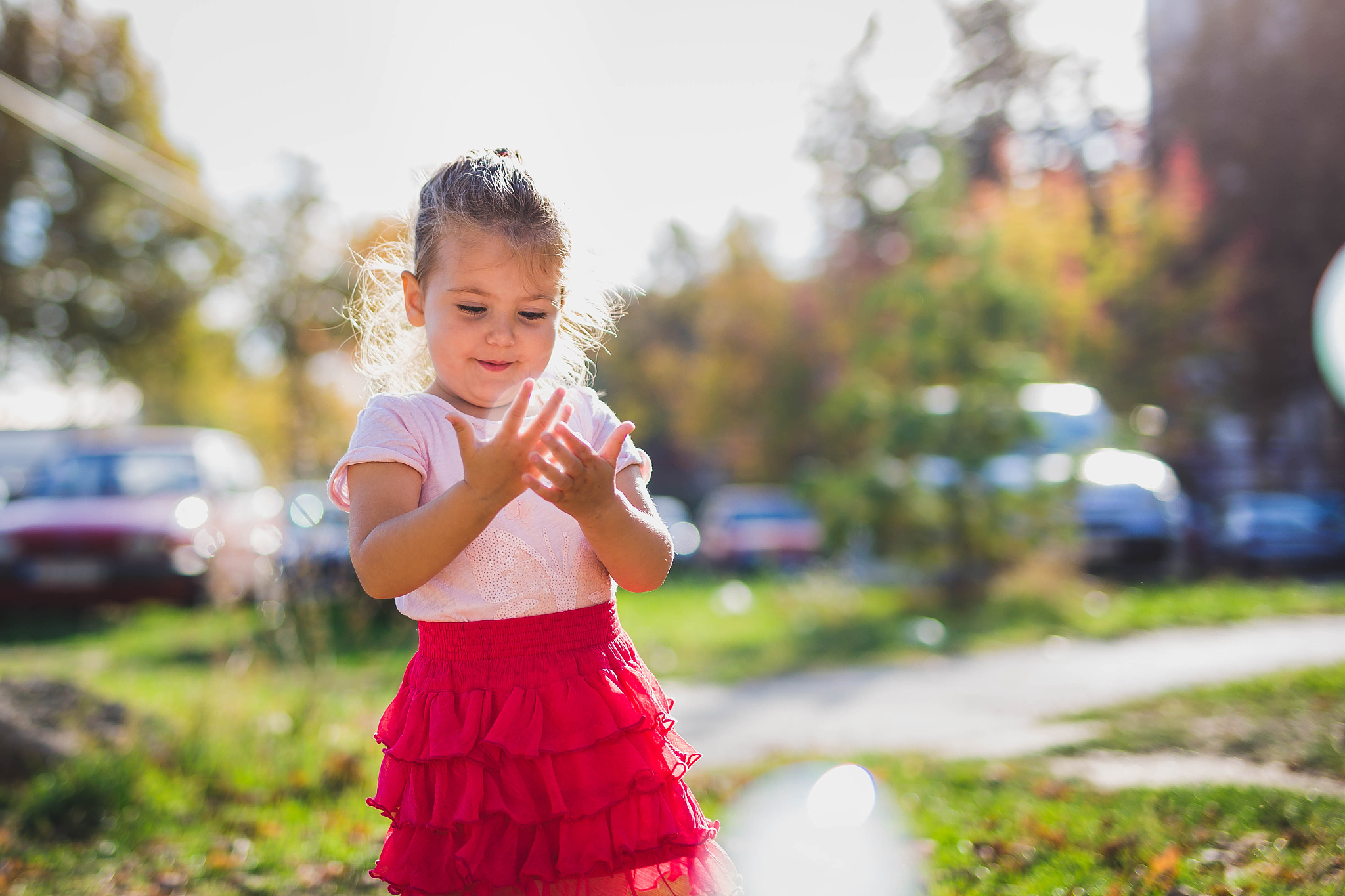 adorable little girl playing in city park