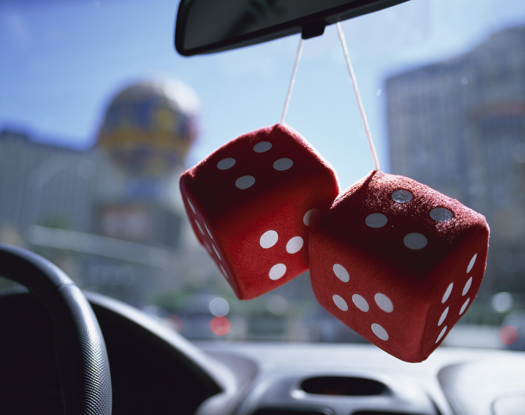 two dice hanging on rear view mirror