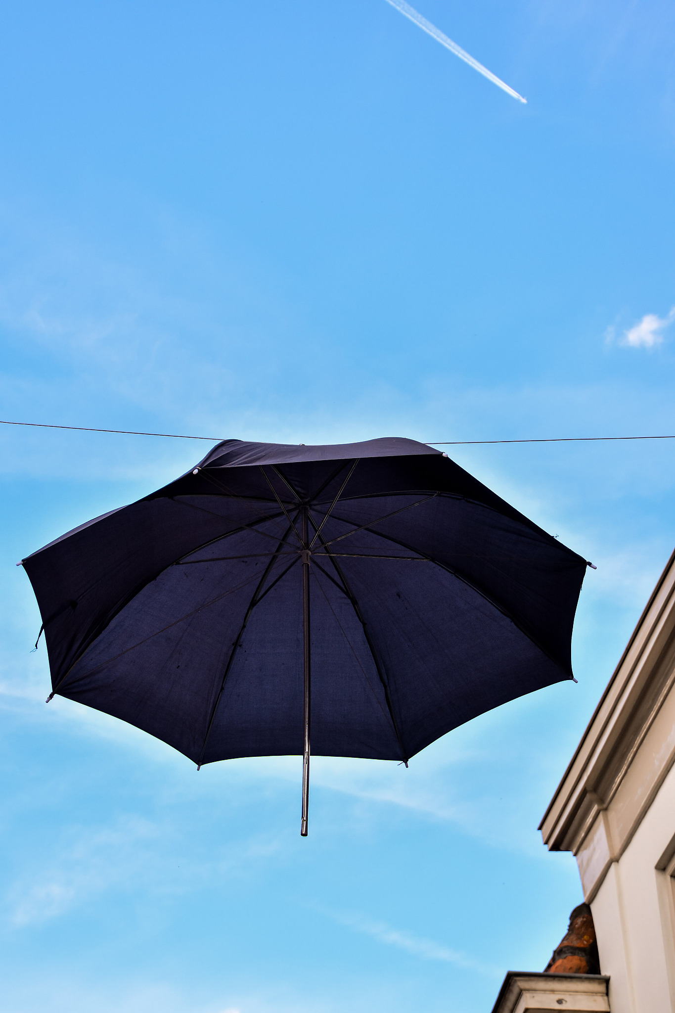 old umbrella against blue sky