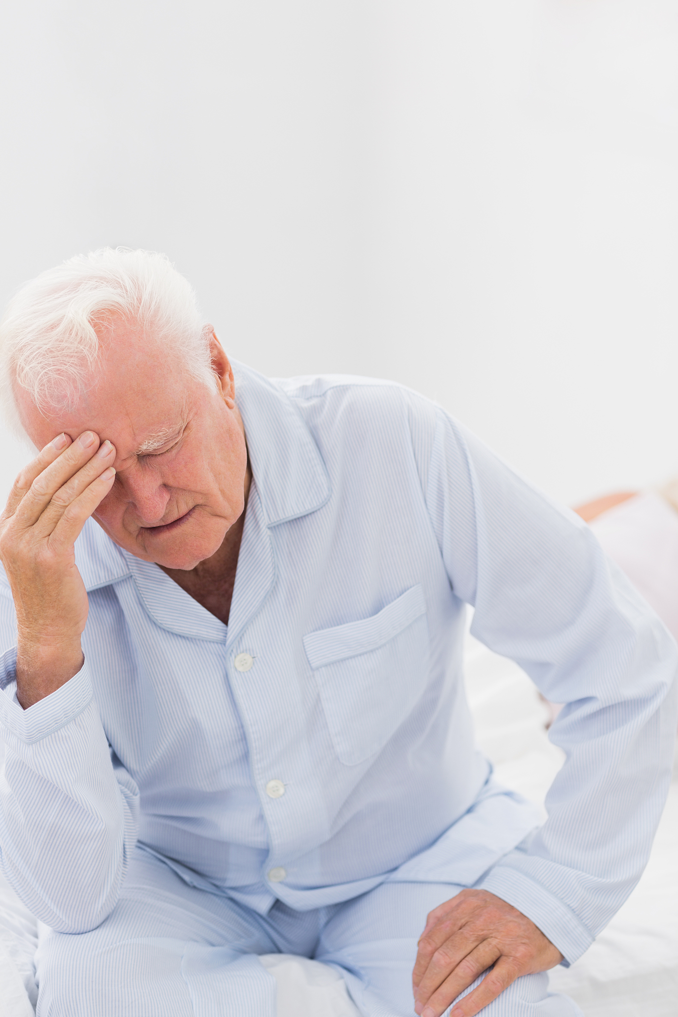 aged man suffering while woman sleeping