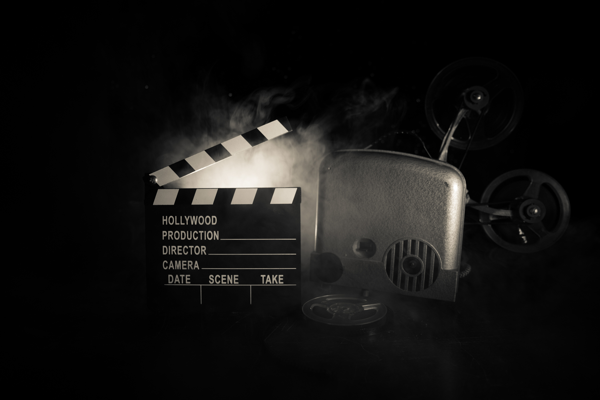 old vintage movie projector on a dark background with fog and li