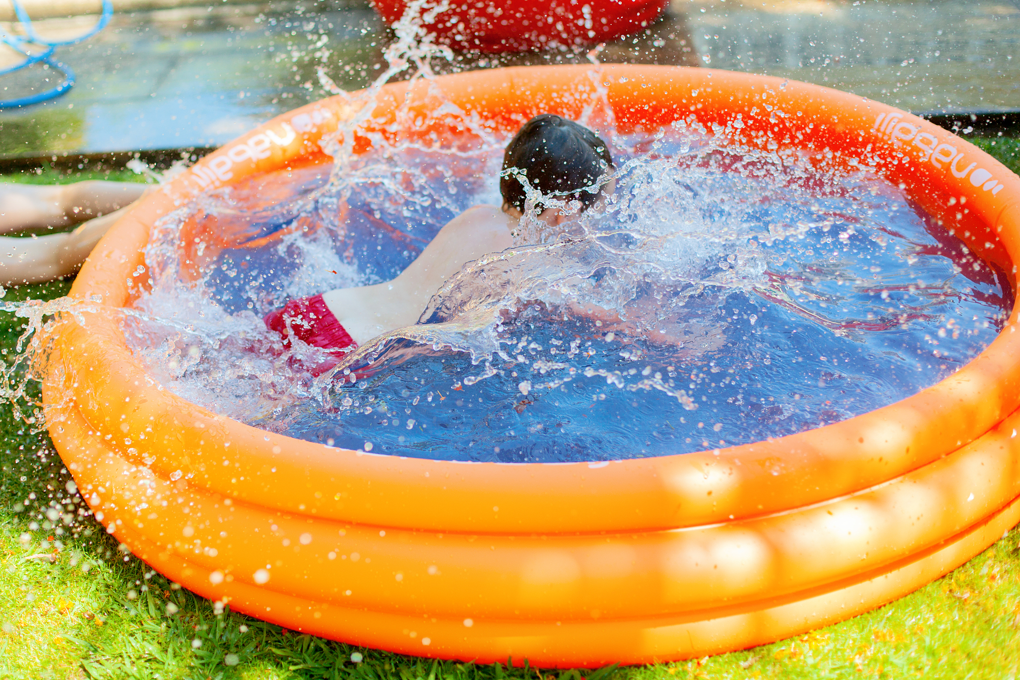 boy(3) having fun in wading pool