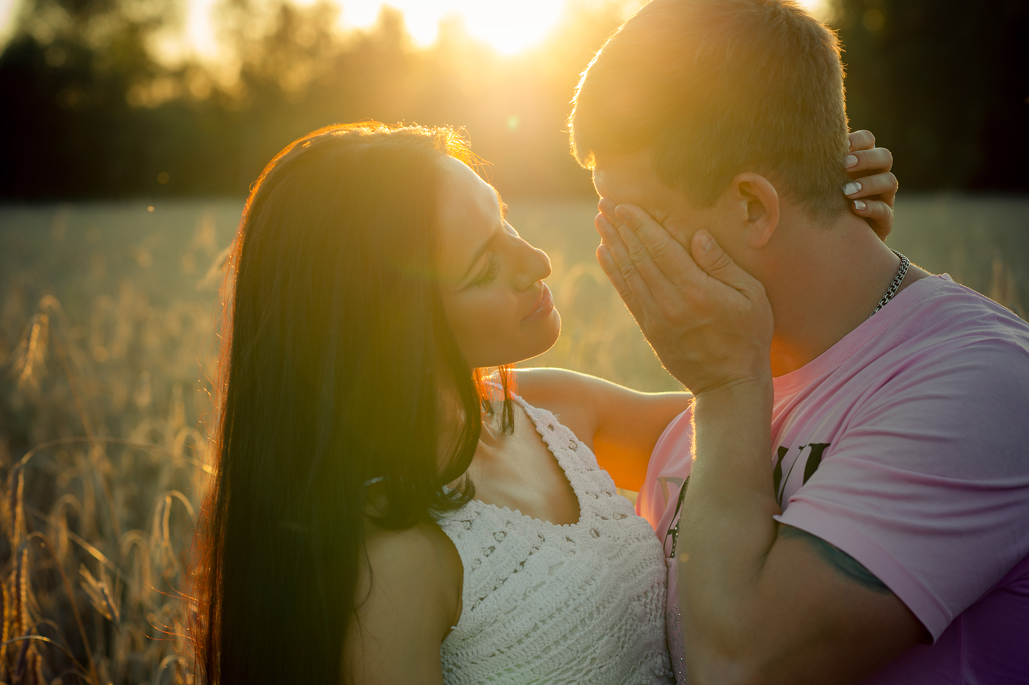 beautiful young couple at sunset in summer
