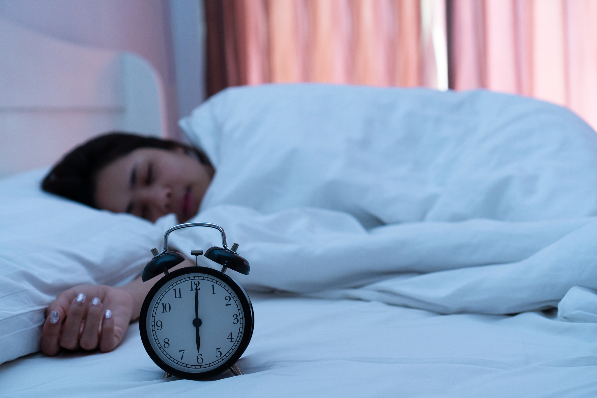 young woman sleeping on bed at home