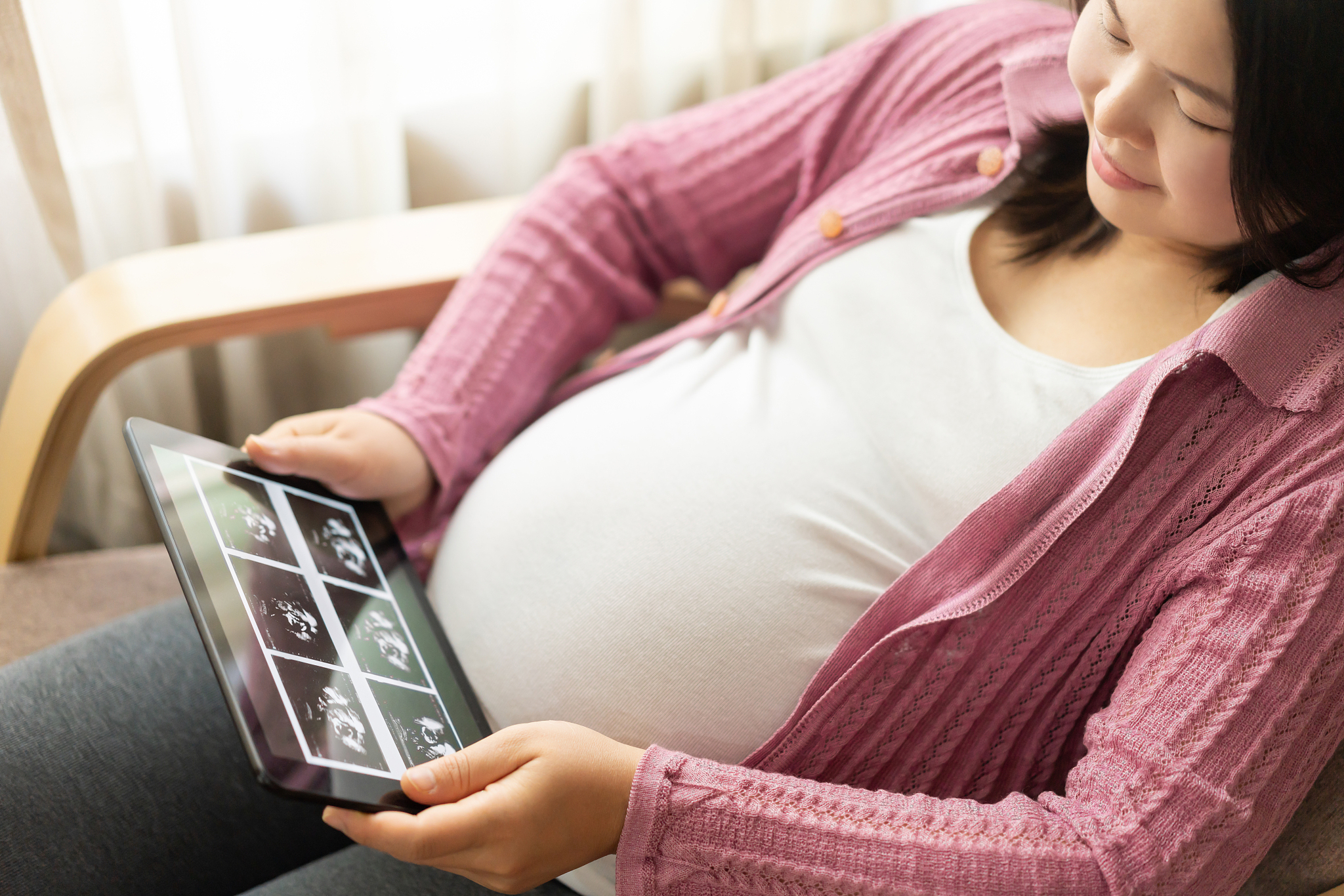 happy pregnant woman and expecting baby at home.