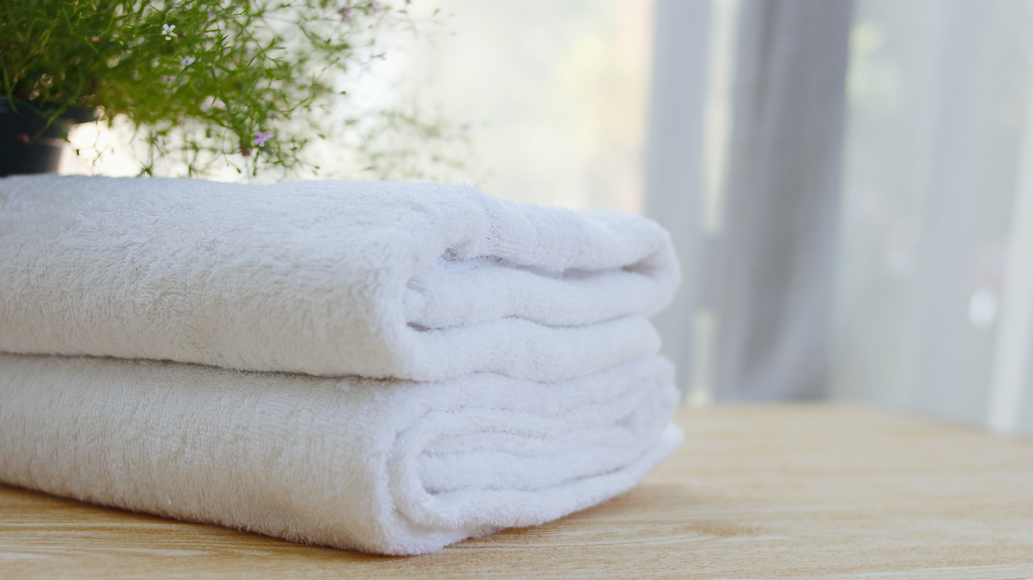 beautifully folded white towels and toiletries. luxury bedroom i