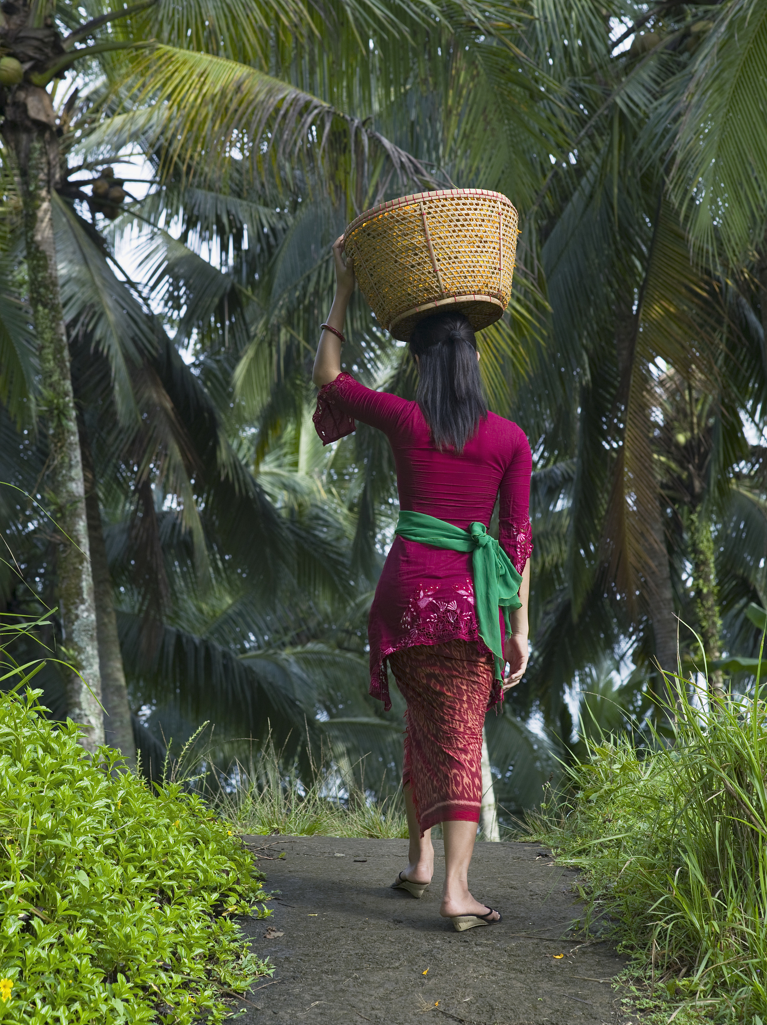 woman carrying basket of flowers